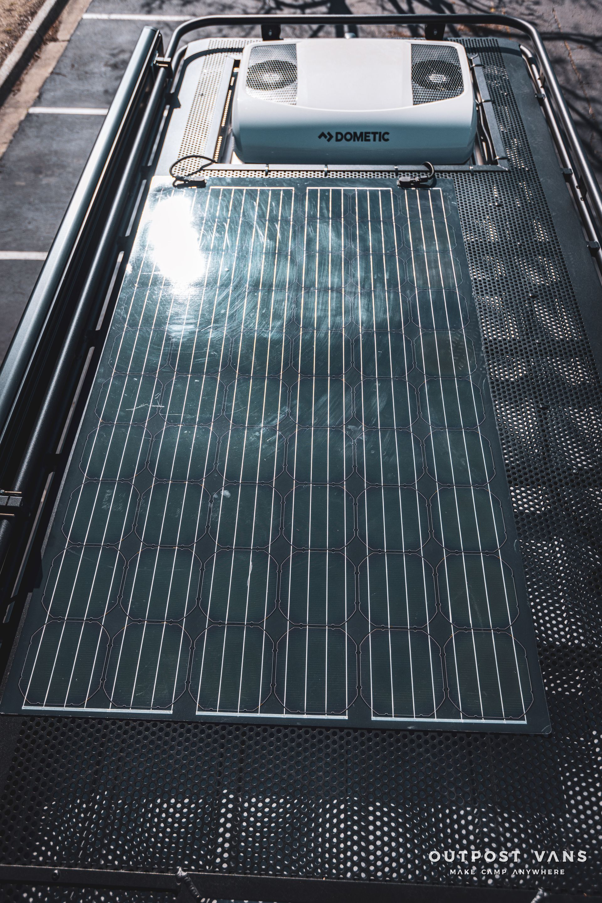 the roof of a van with a cooler on top of it .