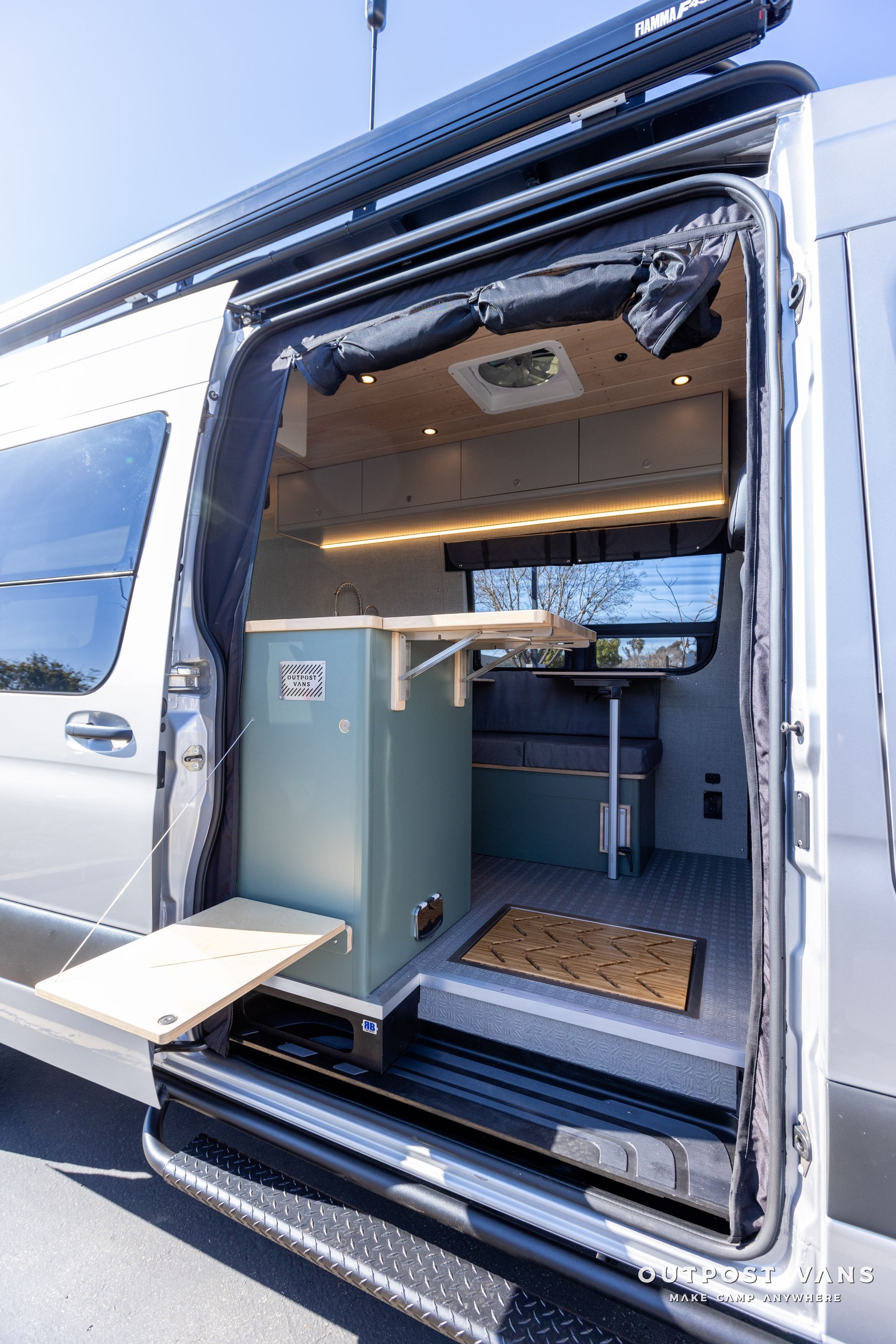 the inside of a van with the door open and a table .