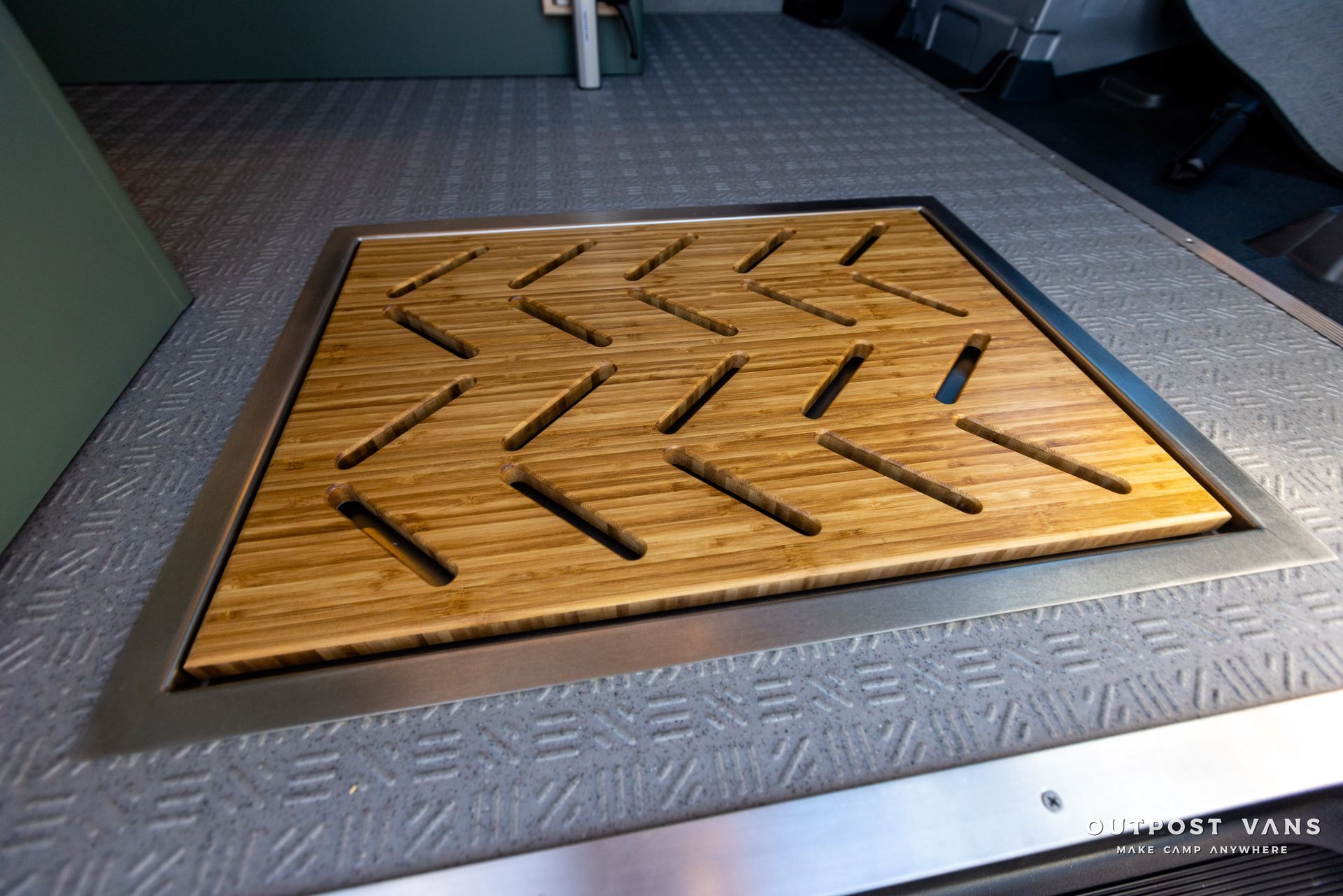 a wooden tray with arrows on it is on the floor in a room .