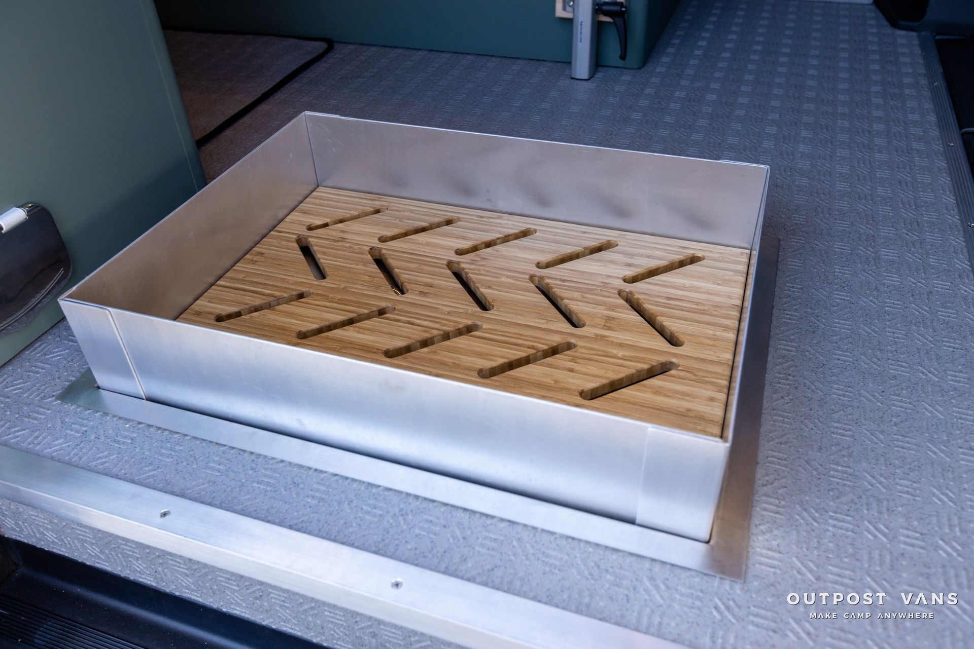 a metal box with a wooden tray on top of it .