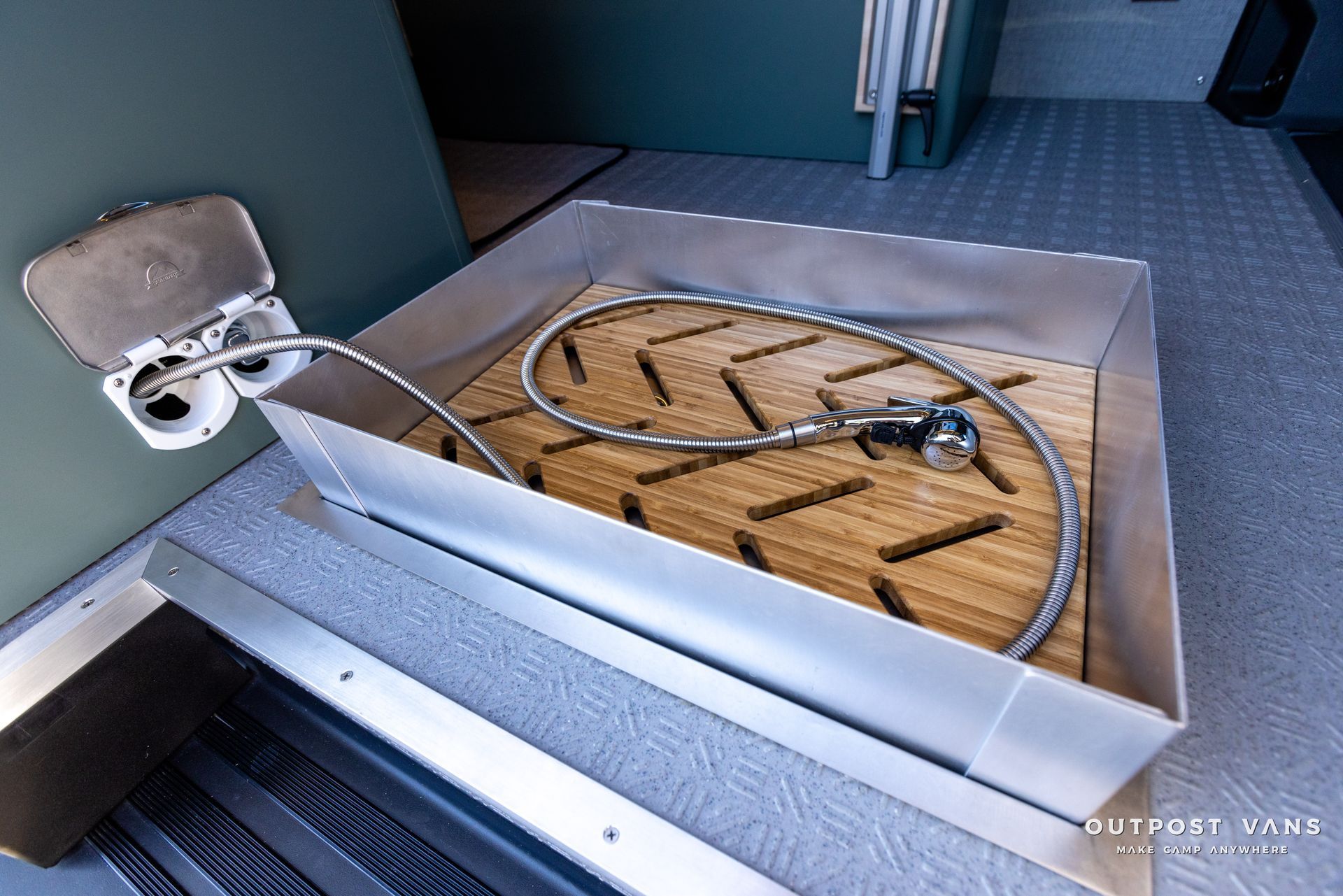 a box with a hose in it is sitting on a wooden floor .