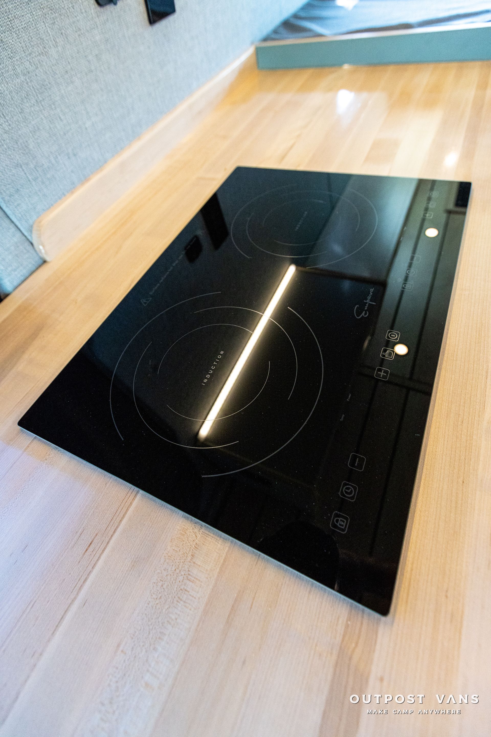 a black stove top oven is sitting on a wooden floor