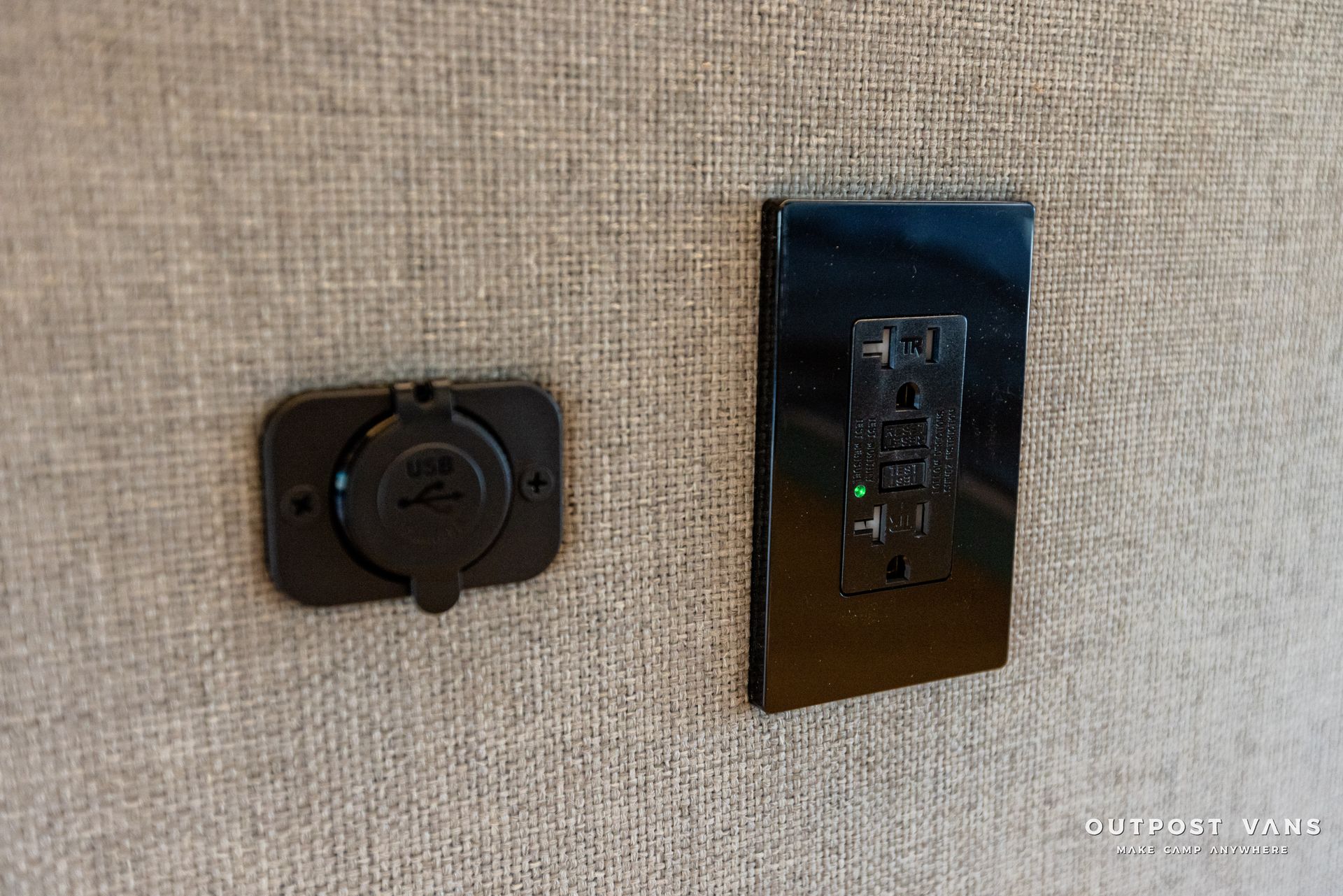 a close up of a light switch and a charger on a wall .