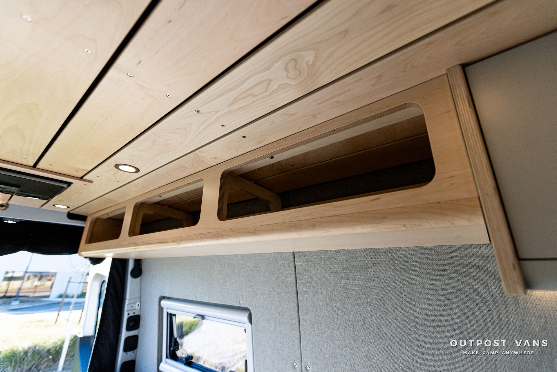 a wooden shelf is hanging from the ceiling of a van .