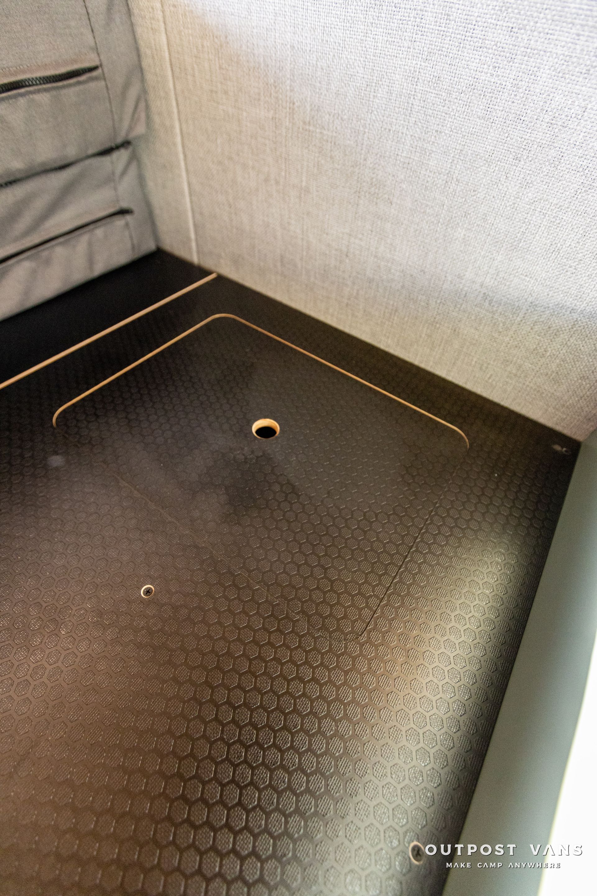 a black floor with a hole in the middle of it .