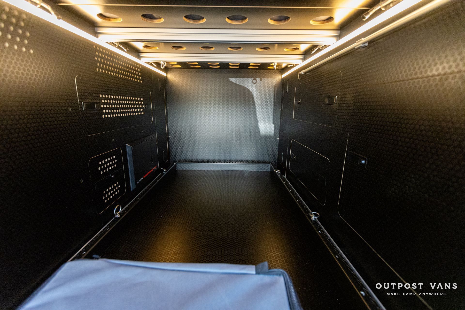 the inside of a black van with lights on the ceiling .