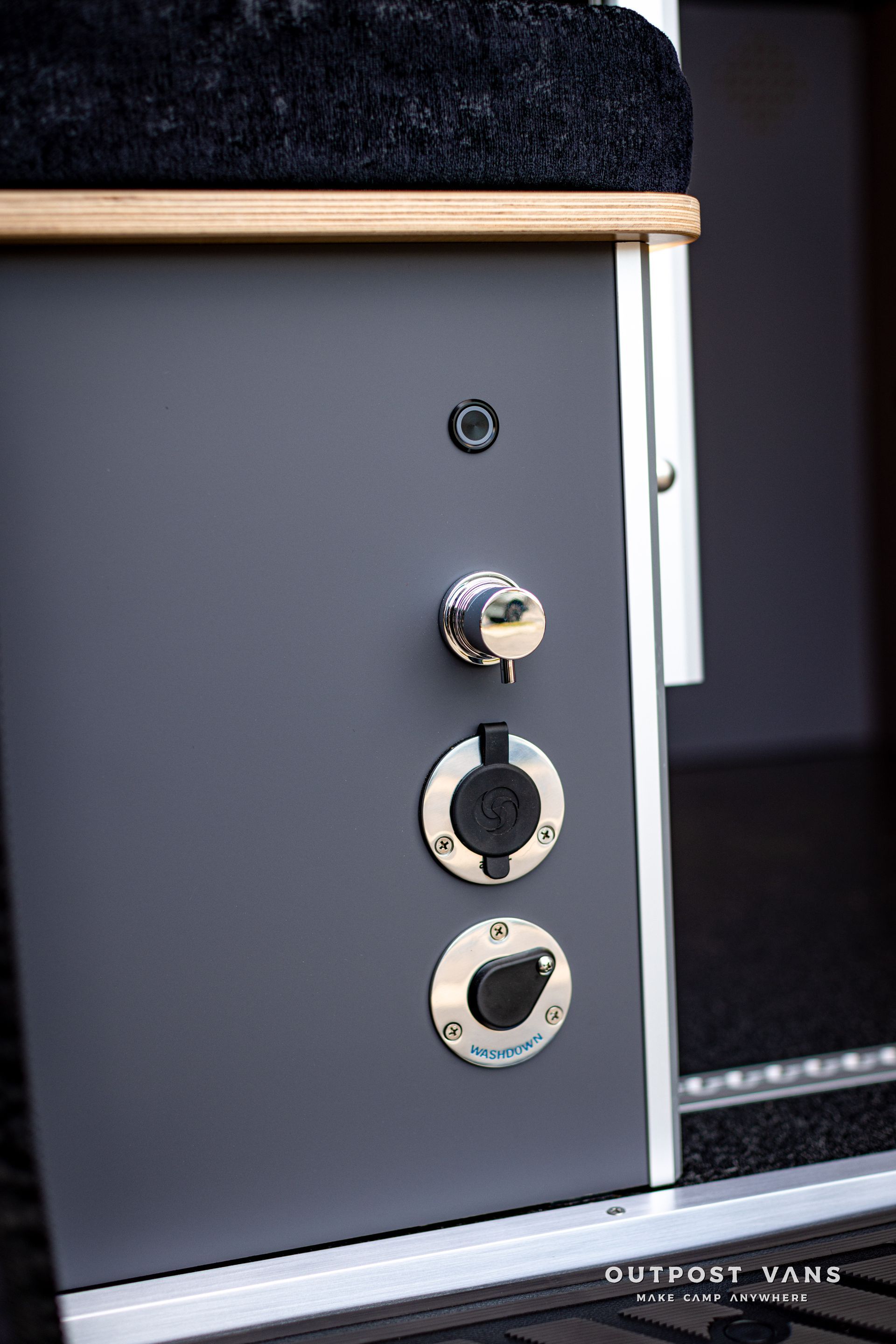 a close up of a gray cabinet with three outlets on it .