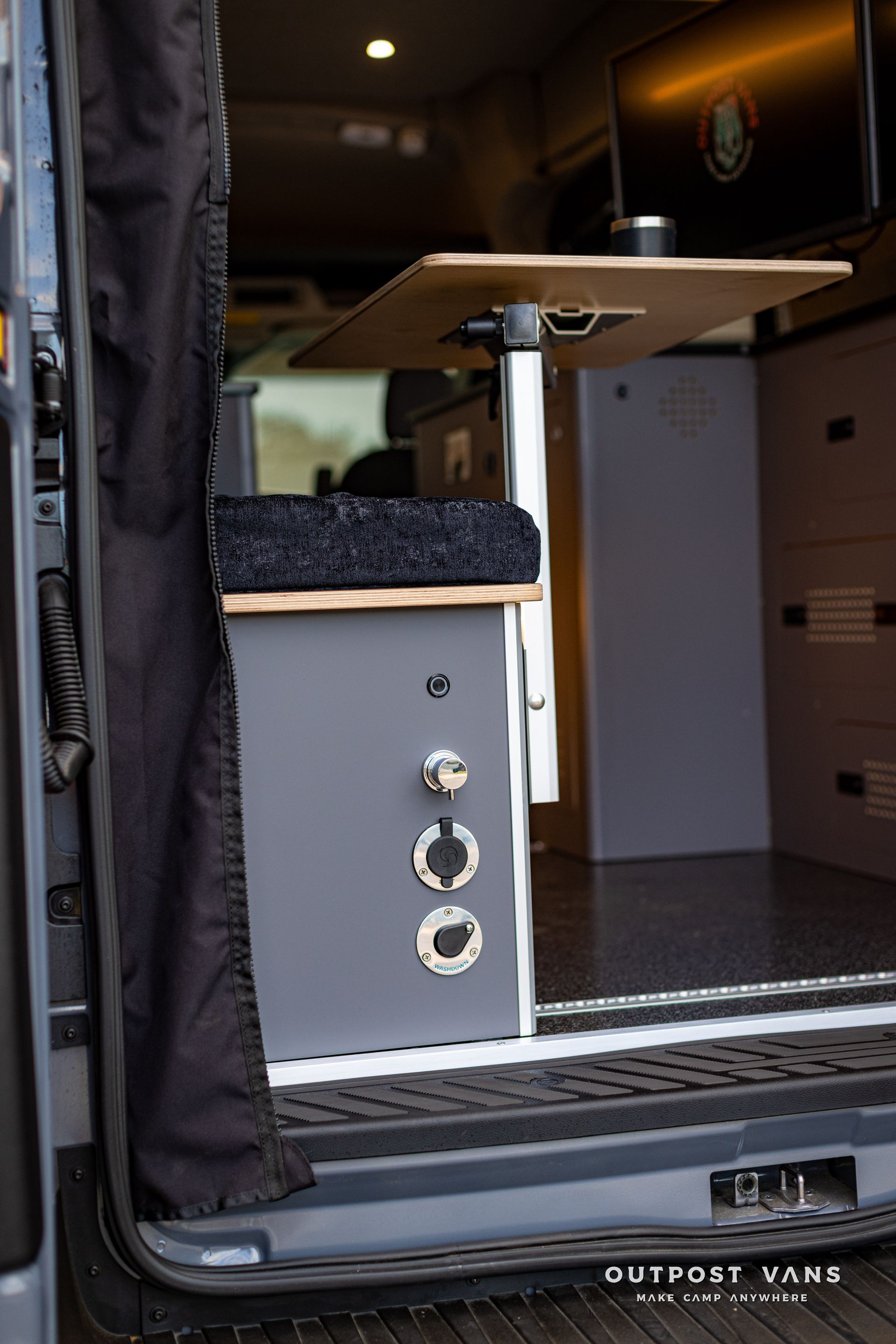 a van with a table in the back of it .