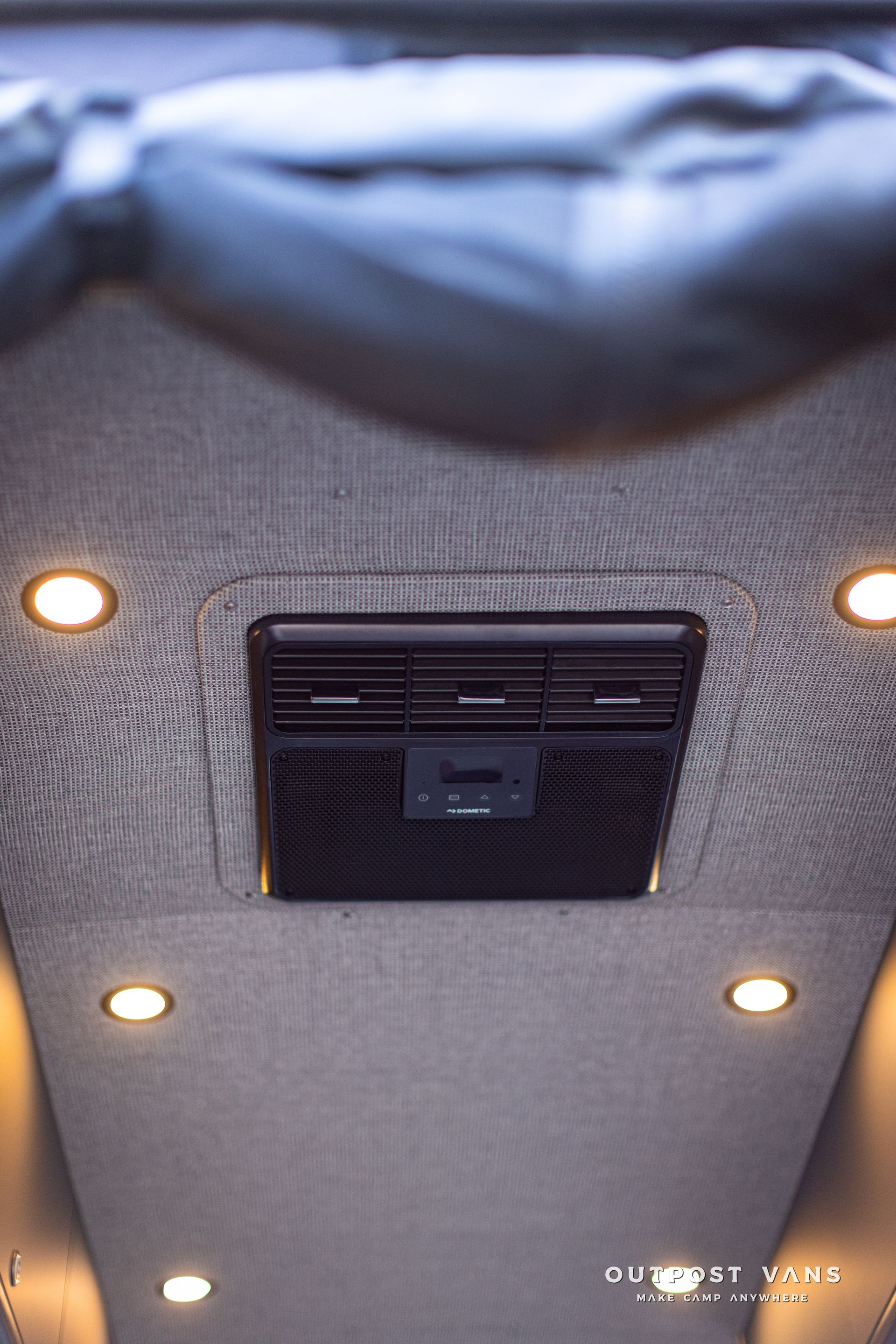 the ceiling of a car with a ceiling fan and lights .