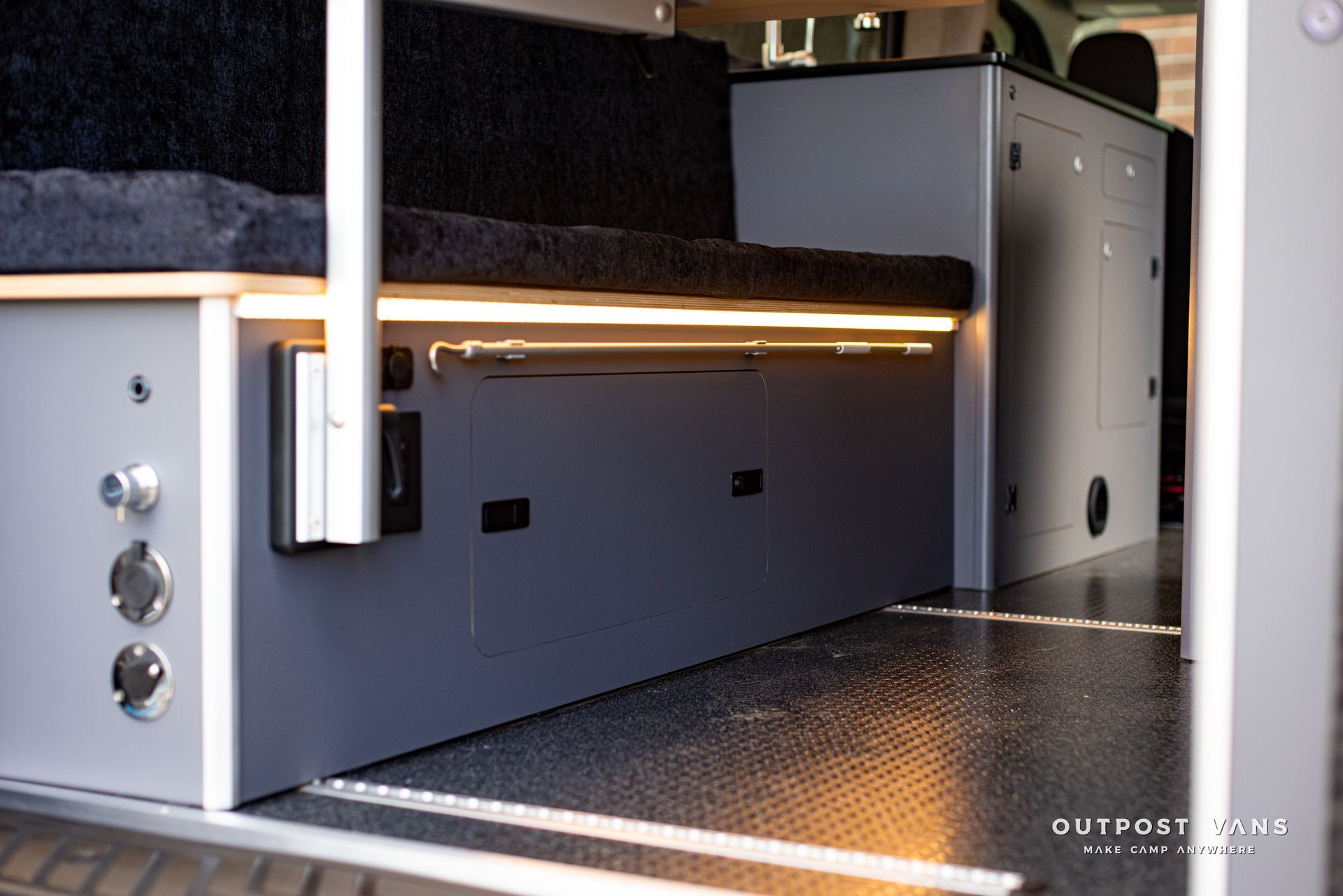 the inside of a camper van with a bed and cabinets .