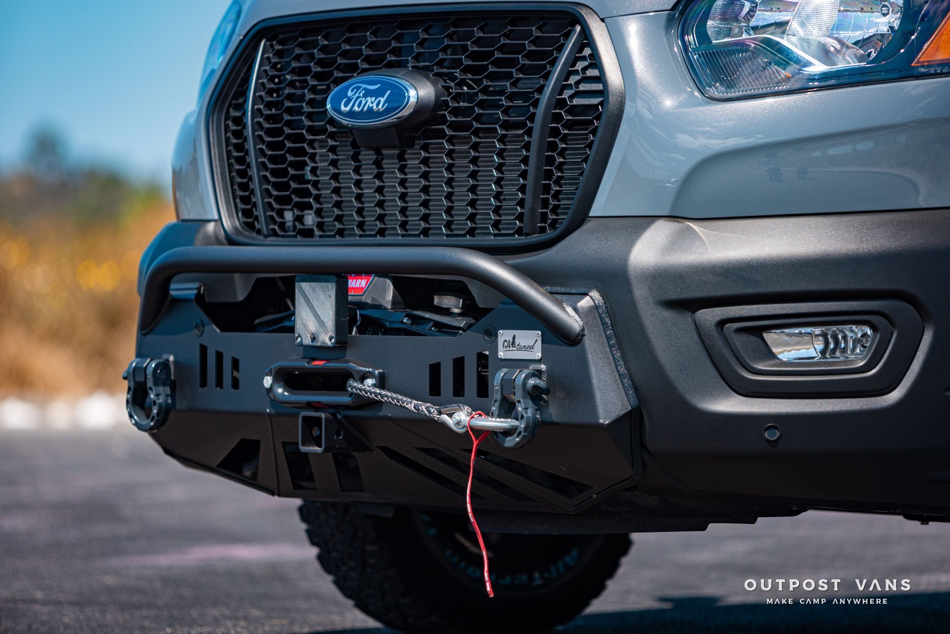 the front bumper of a ford transit with a winch attached to it .