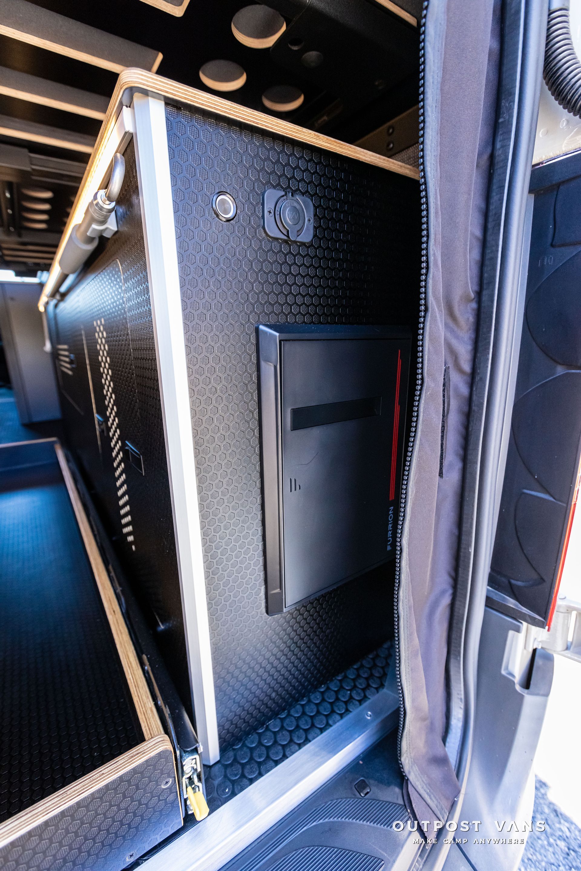 A black box is sitting in the back of a van.