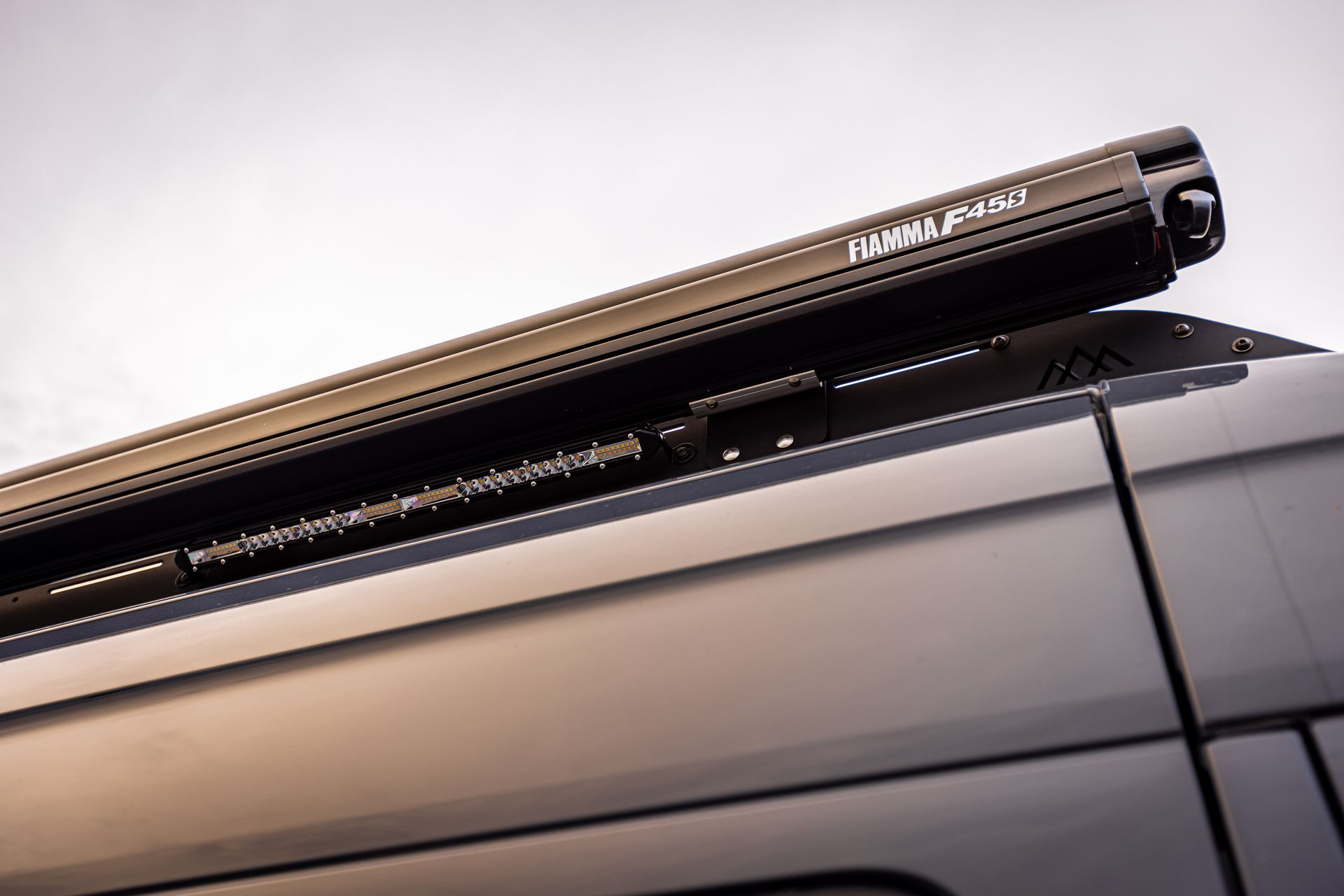 A close up of a roof rack on the side of a van.