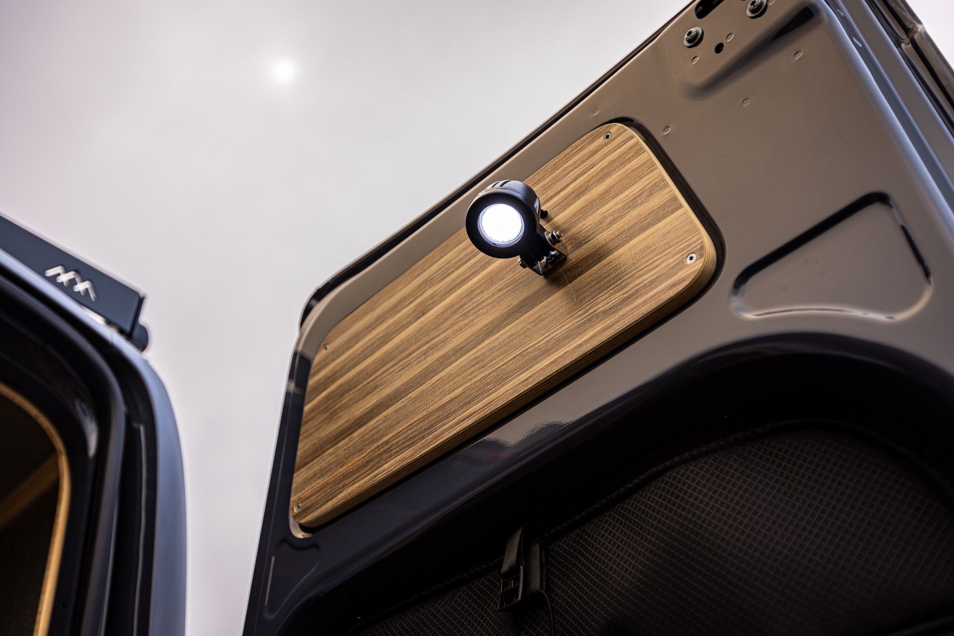 A close up of a wooden door with a light on it