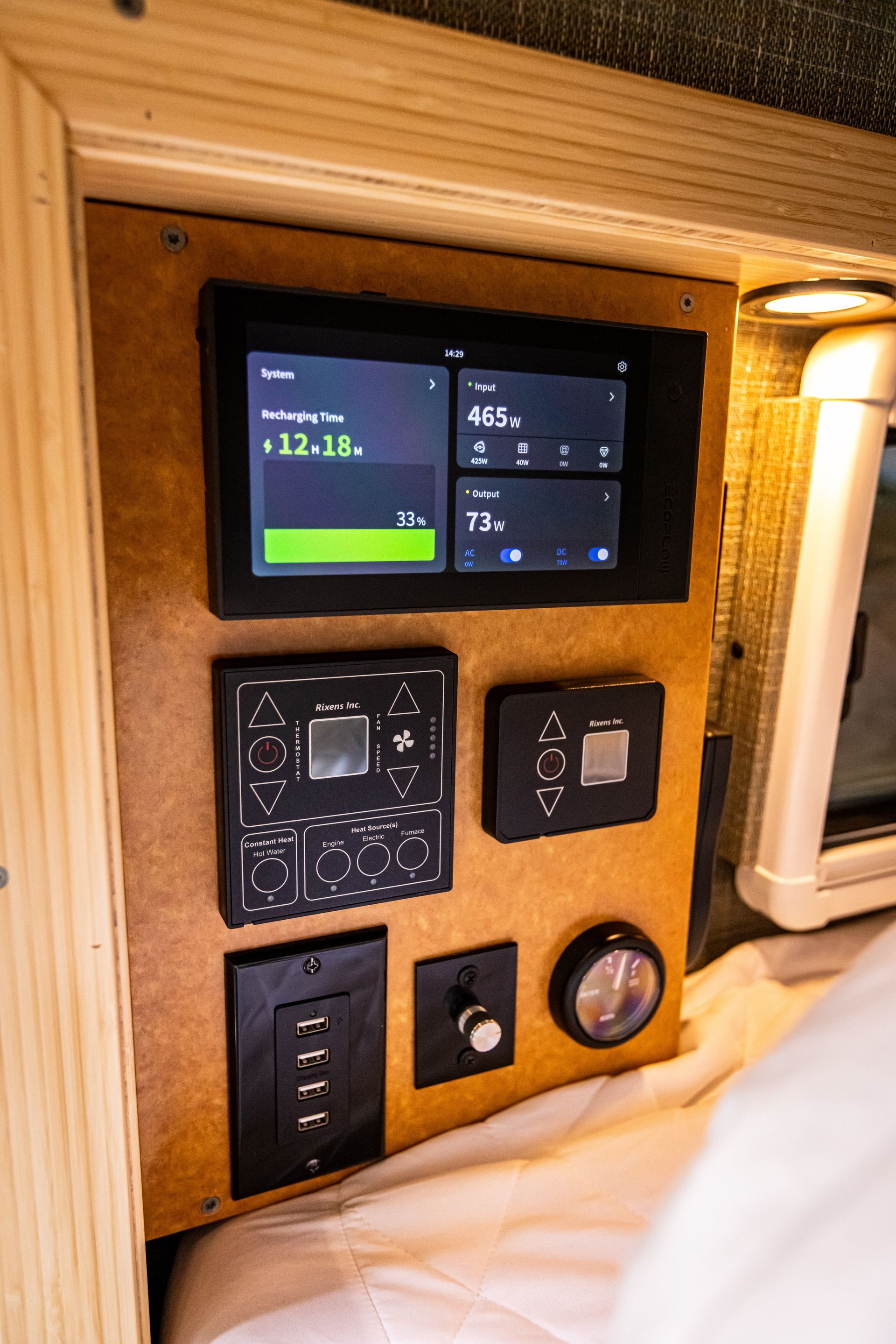 A wooden panel with a touchscreen and a clock on it.