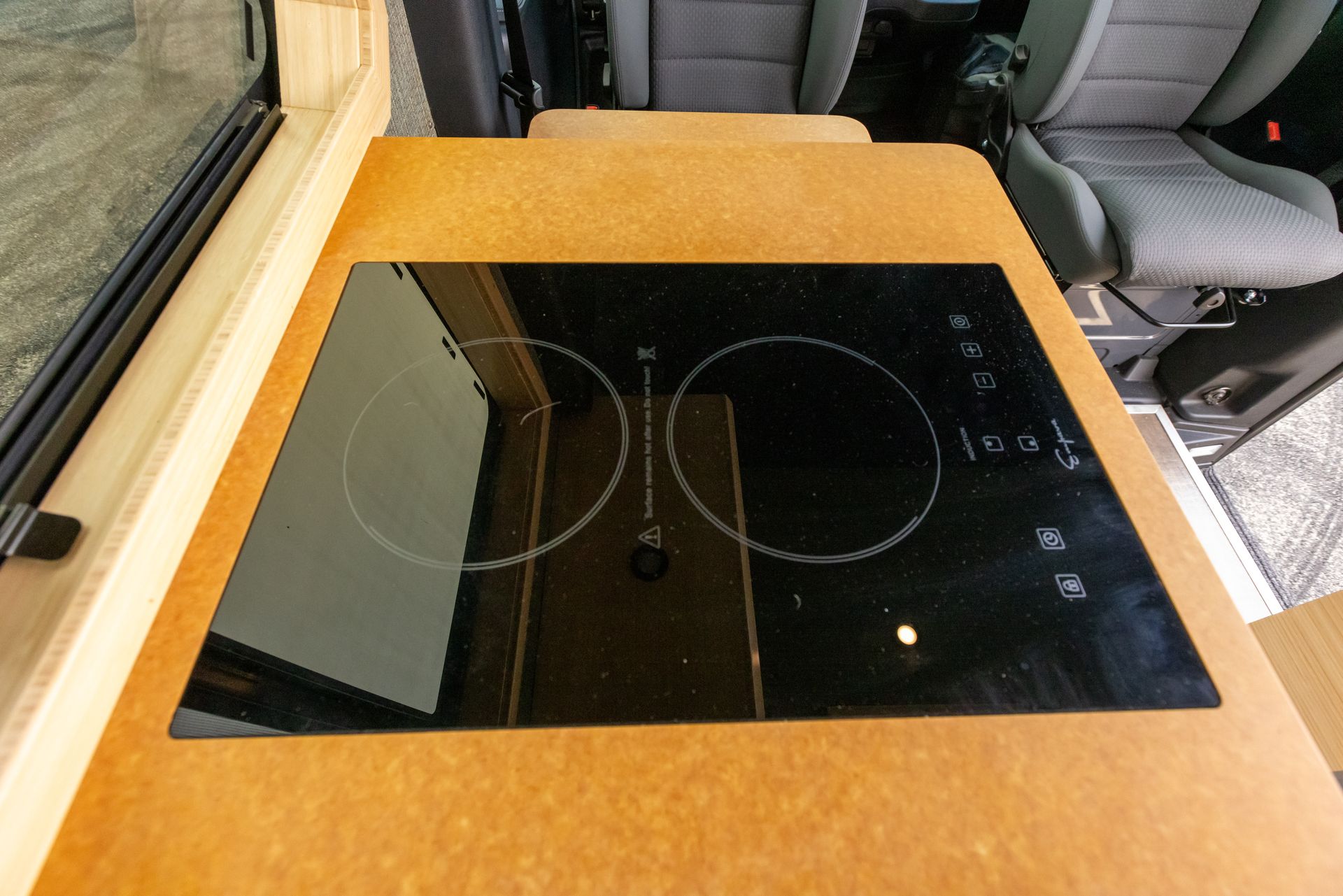 A stove top oven is sitting on top of a wooden table.
