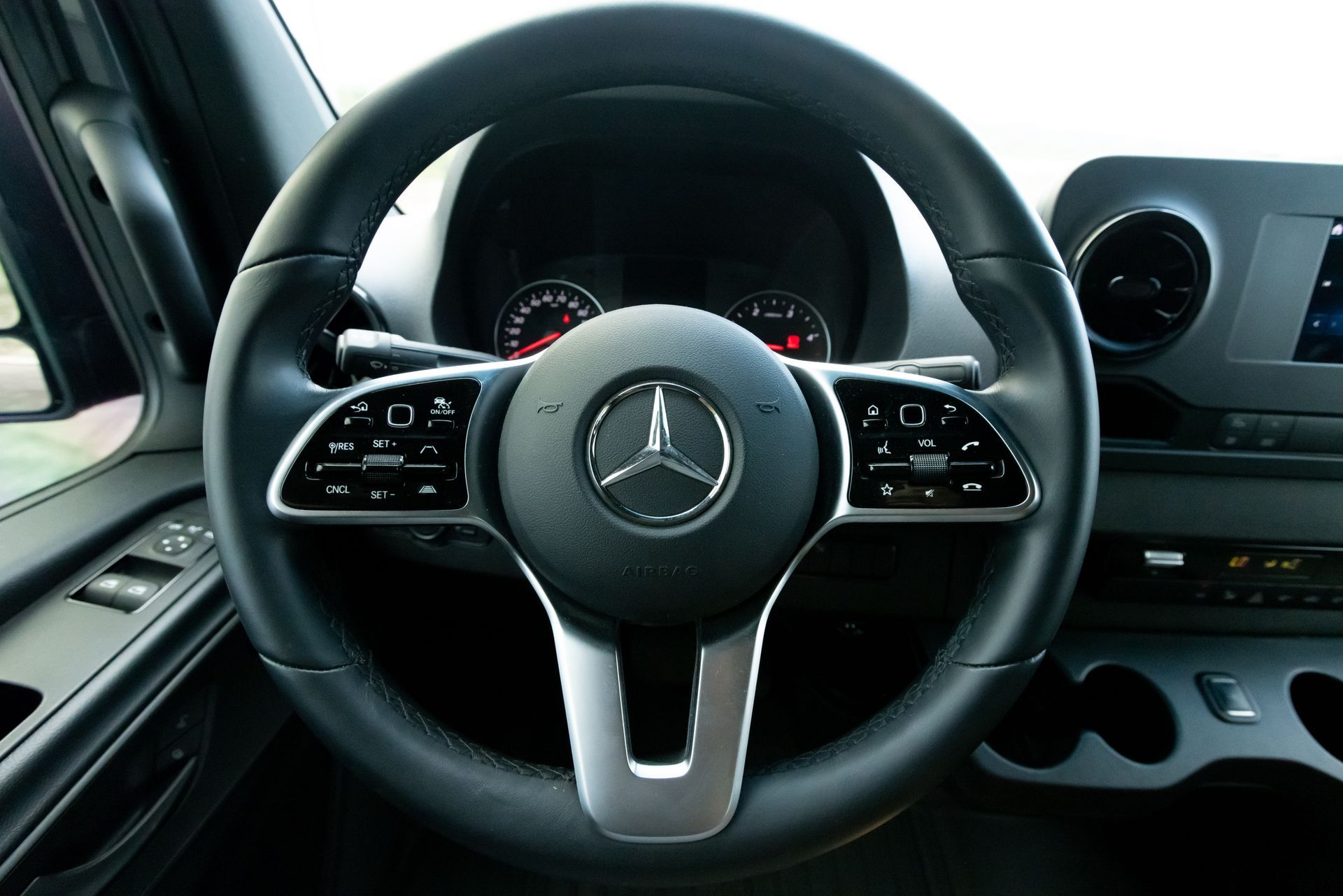 A close up of a mercedes benz steering wheel
