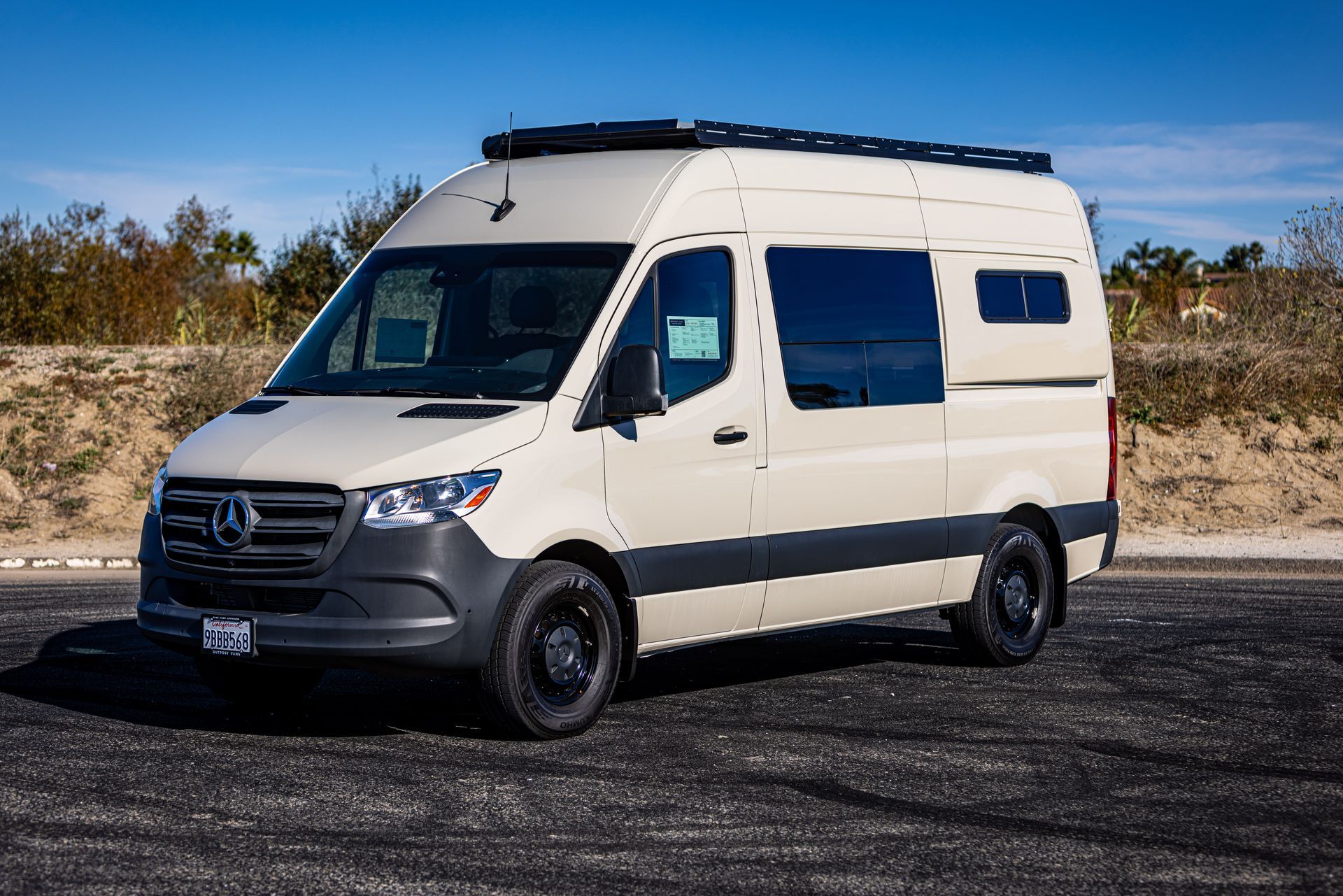 A white van is parked on the side of the road.