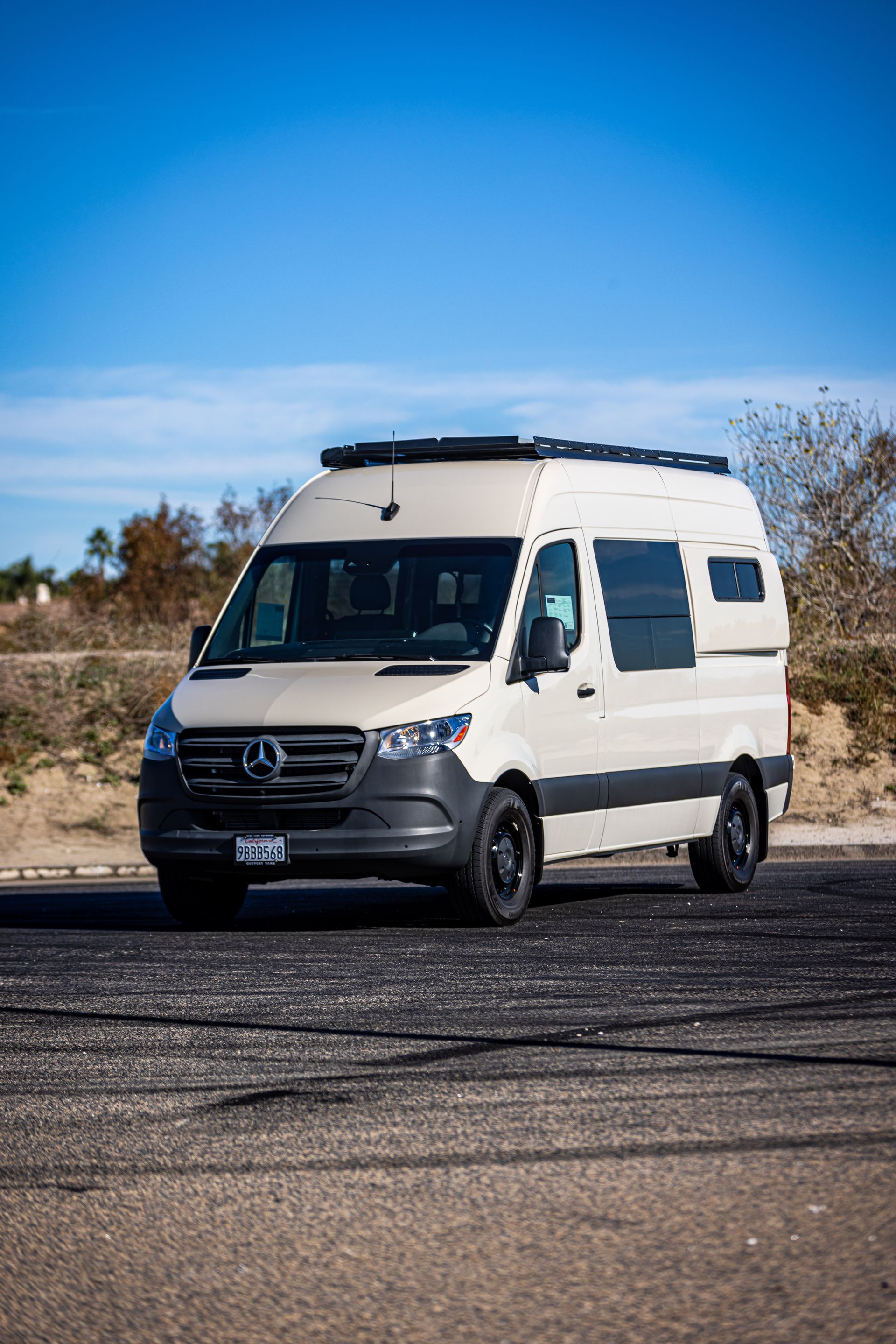 A white van is parked on the side of the road.