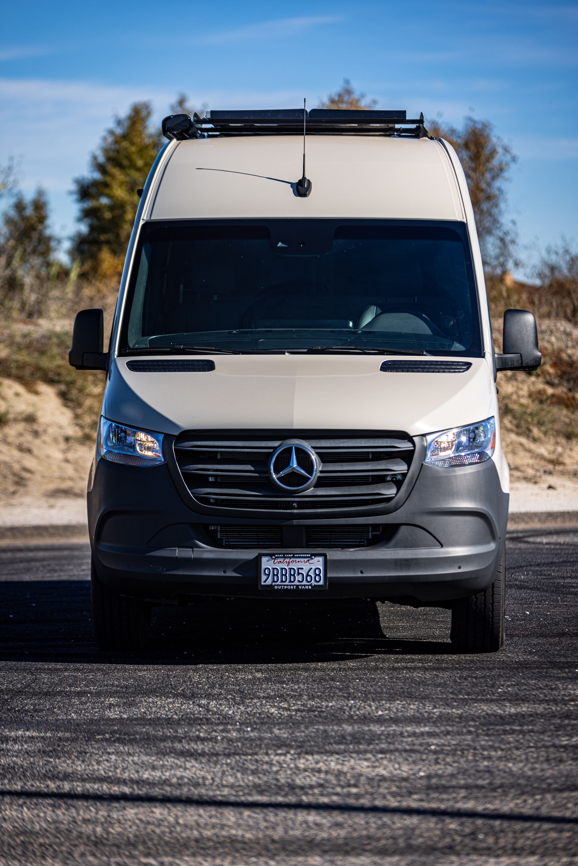 A white van is parked on the side of the road.