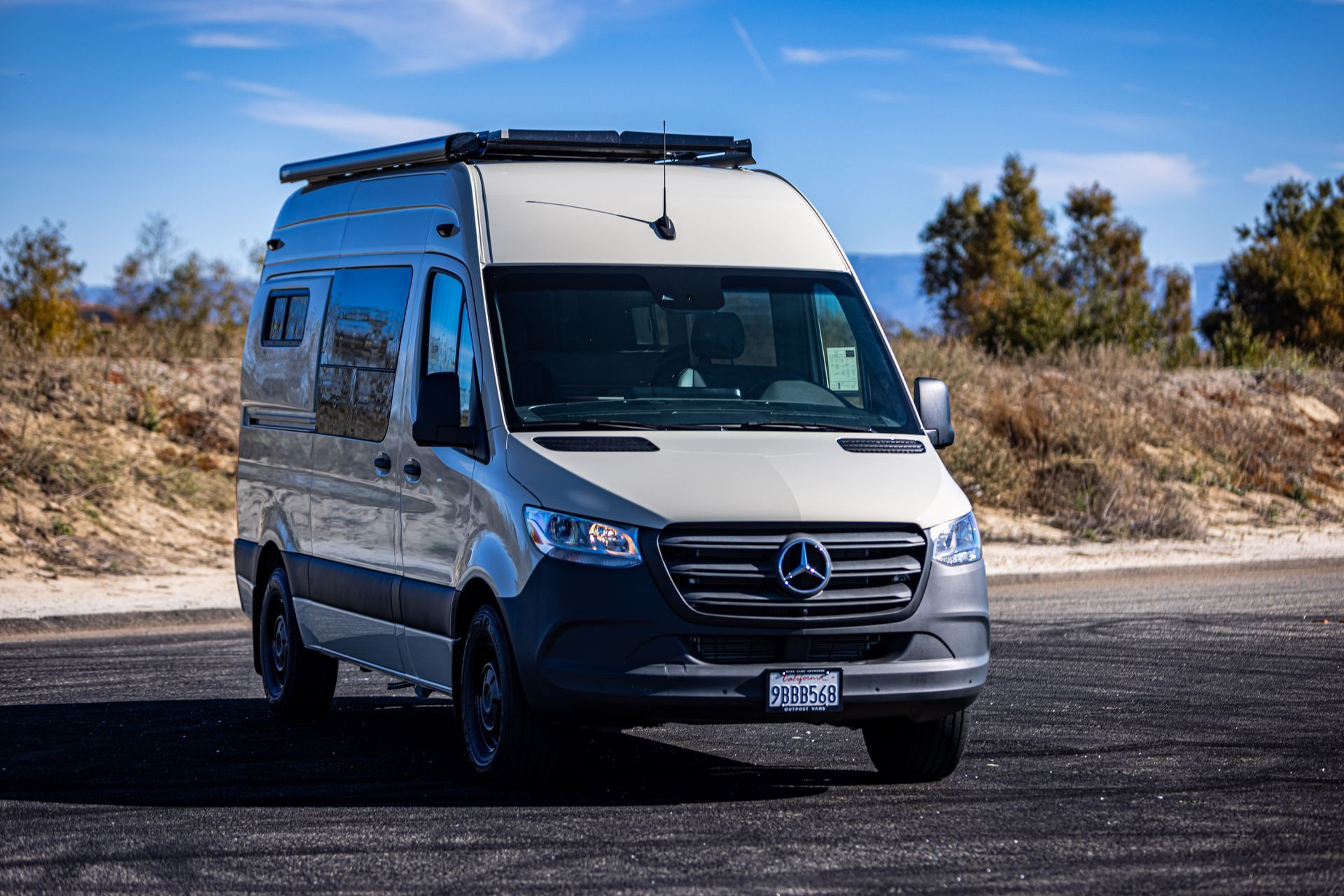 A white van is parked on the side of the road.