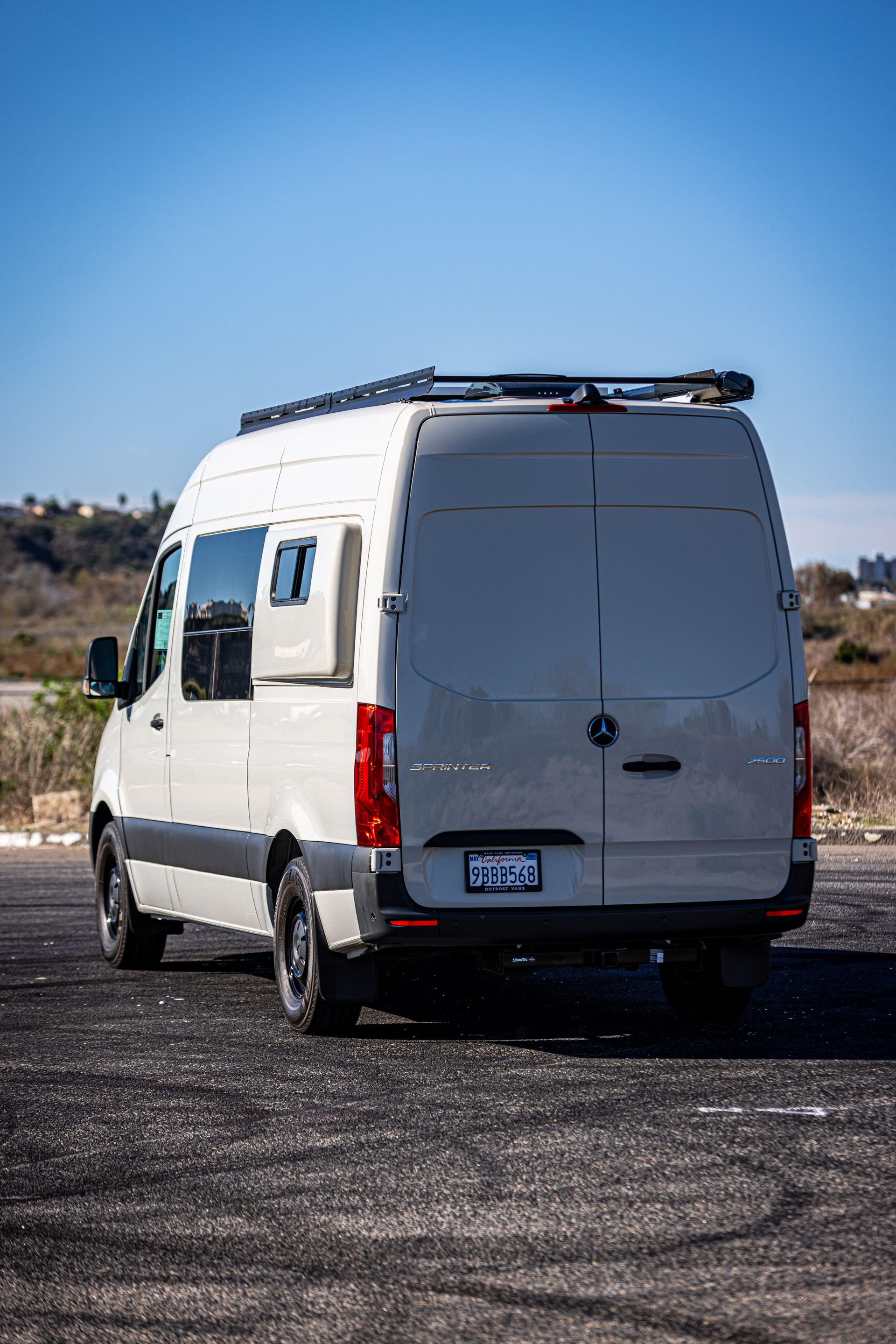 A white van is parked in a parking lot.