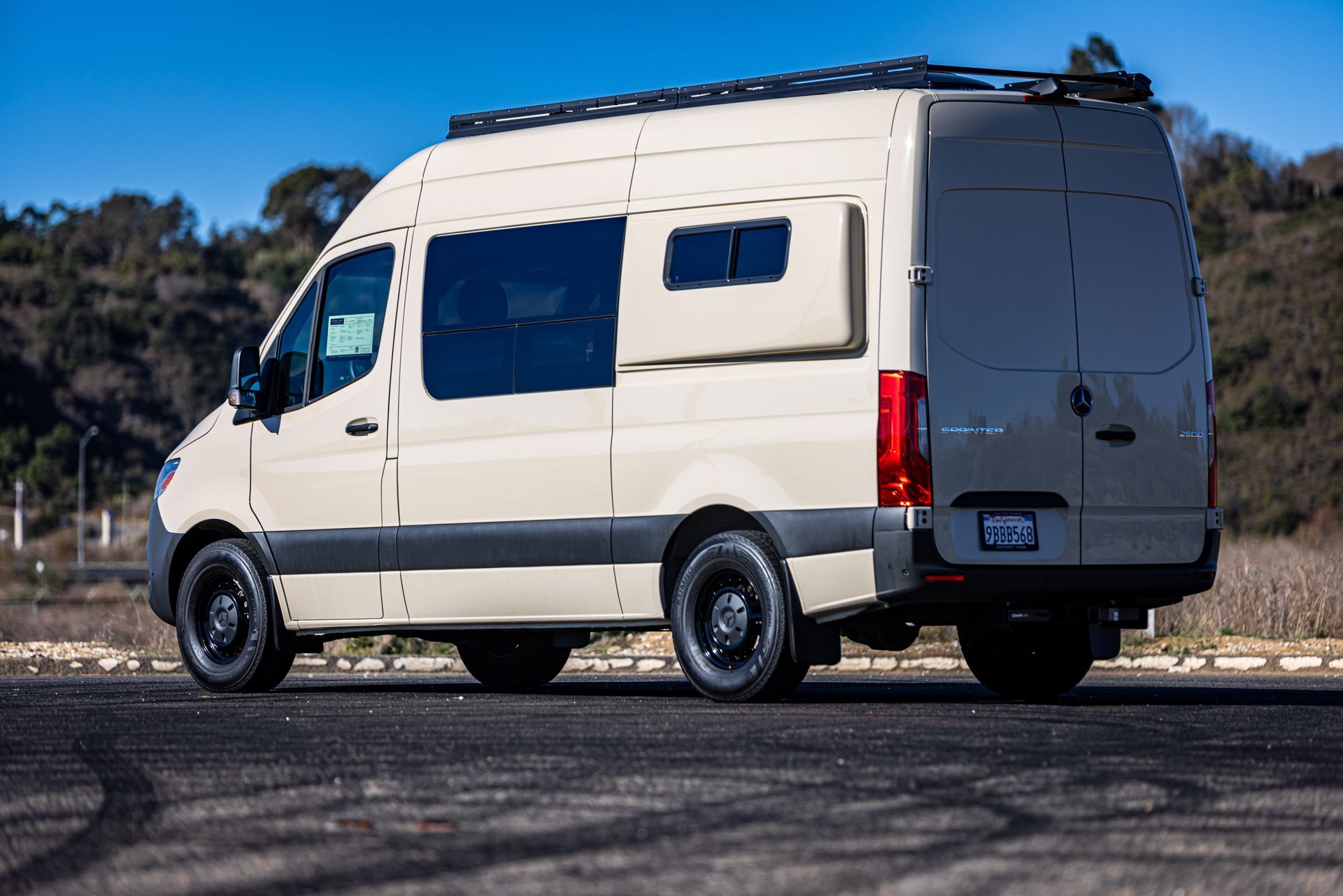A white van is parked on the side of the road.