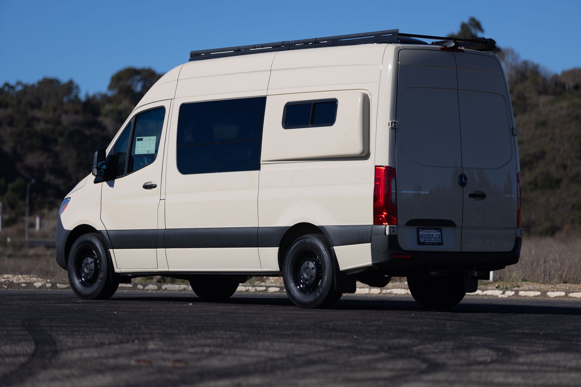 A white van is parked on the side of the road.