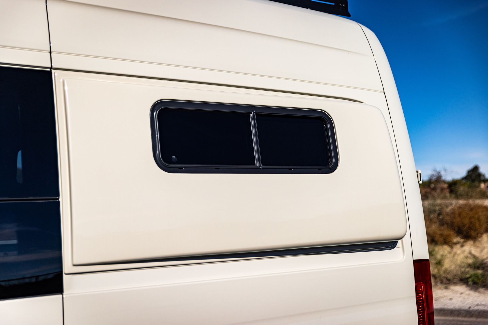 A white van with a window on the side of it.