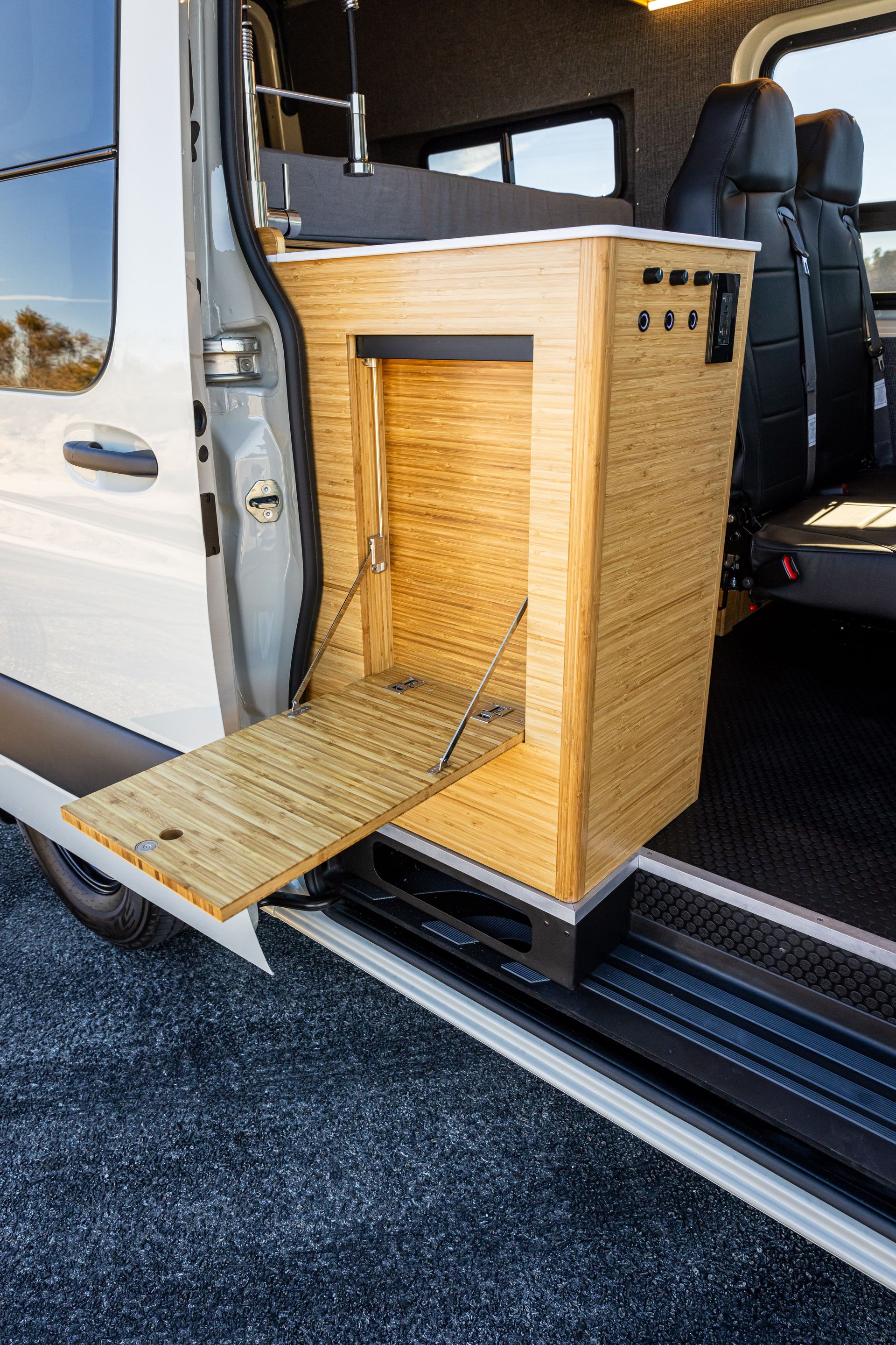 A white van with a wooden box in the back of it.