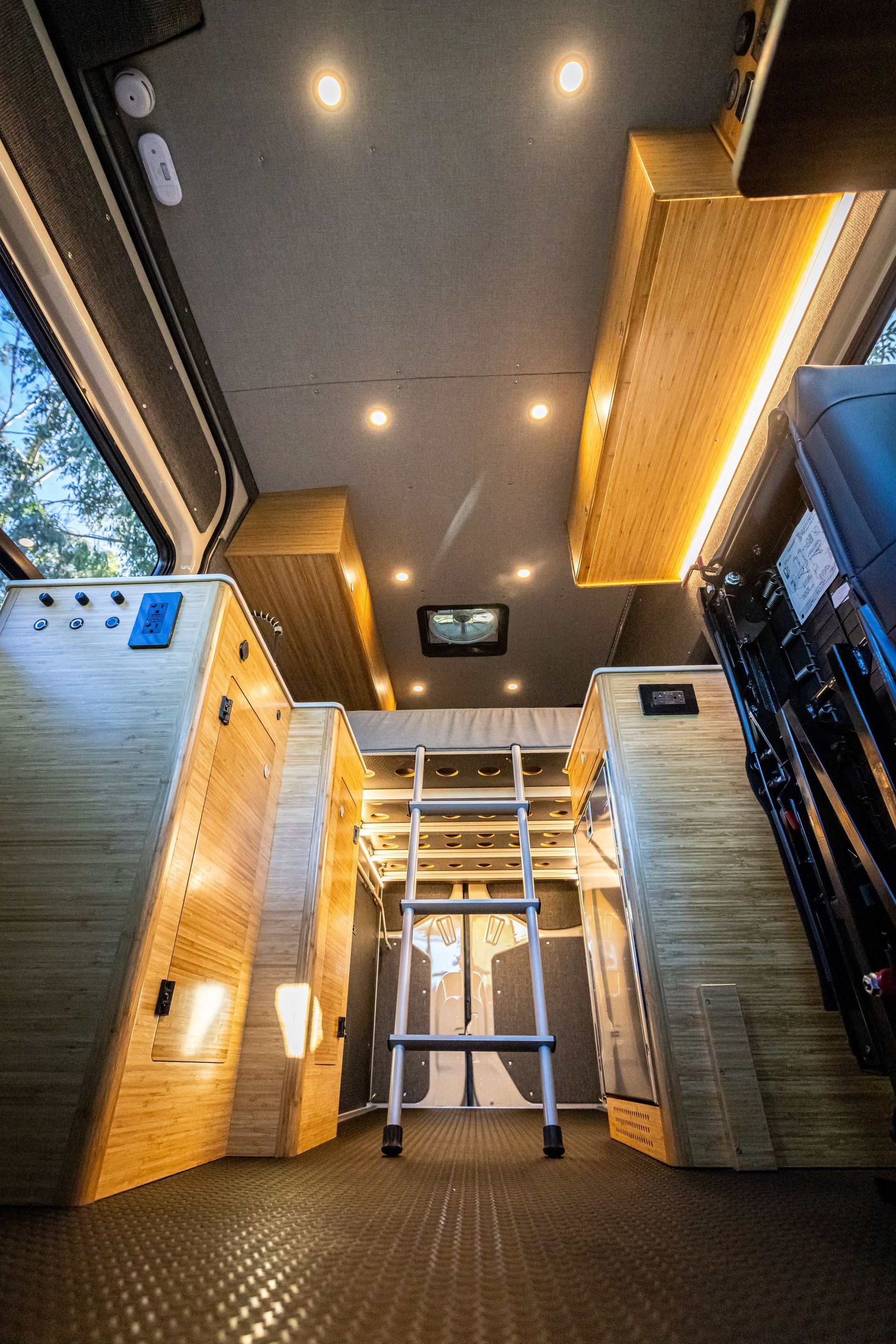 the inside of a van with a ladder leading up to the ceiling .