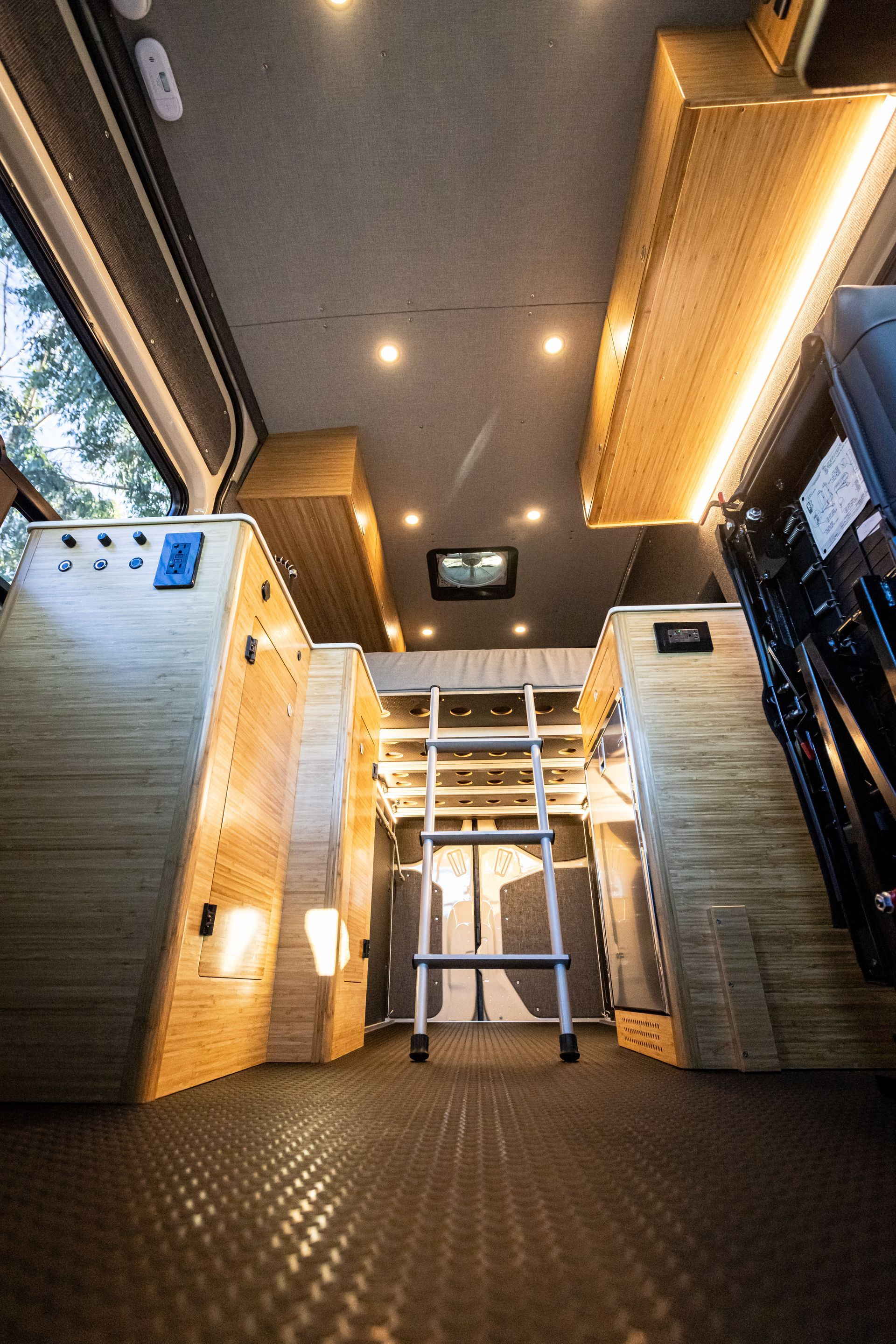 a ladder is hanging from the ceiling of a van .