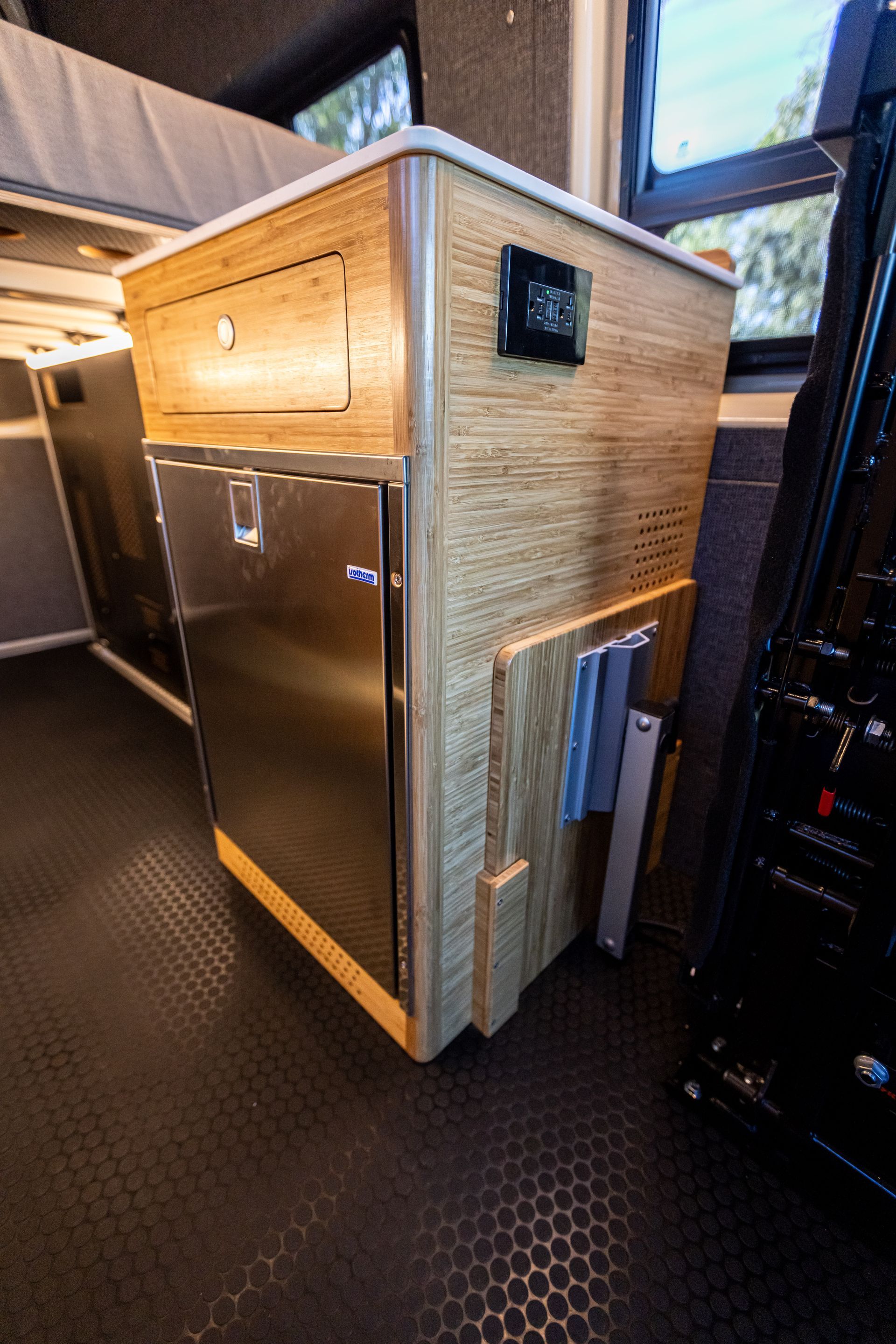 a kitchen with a stainless steel refrigerator and a wooden cabinet .