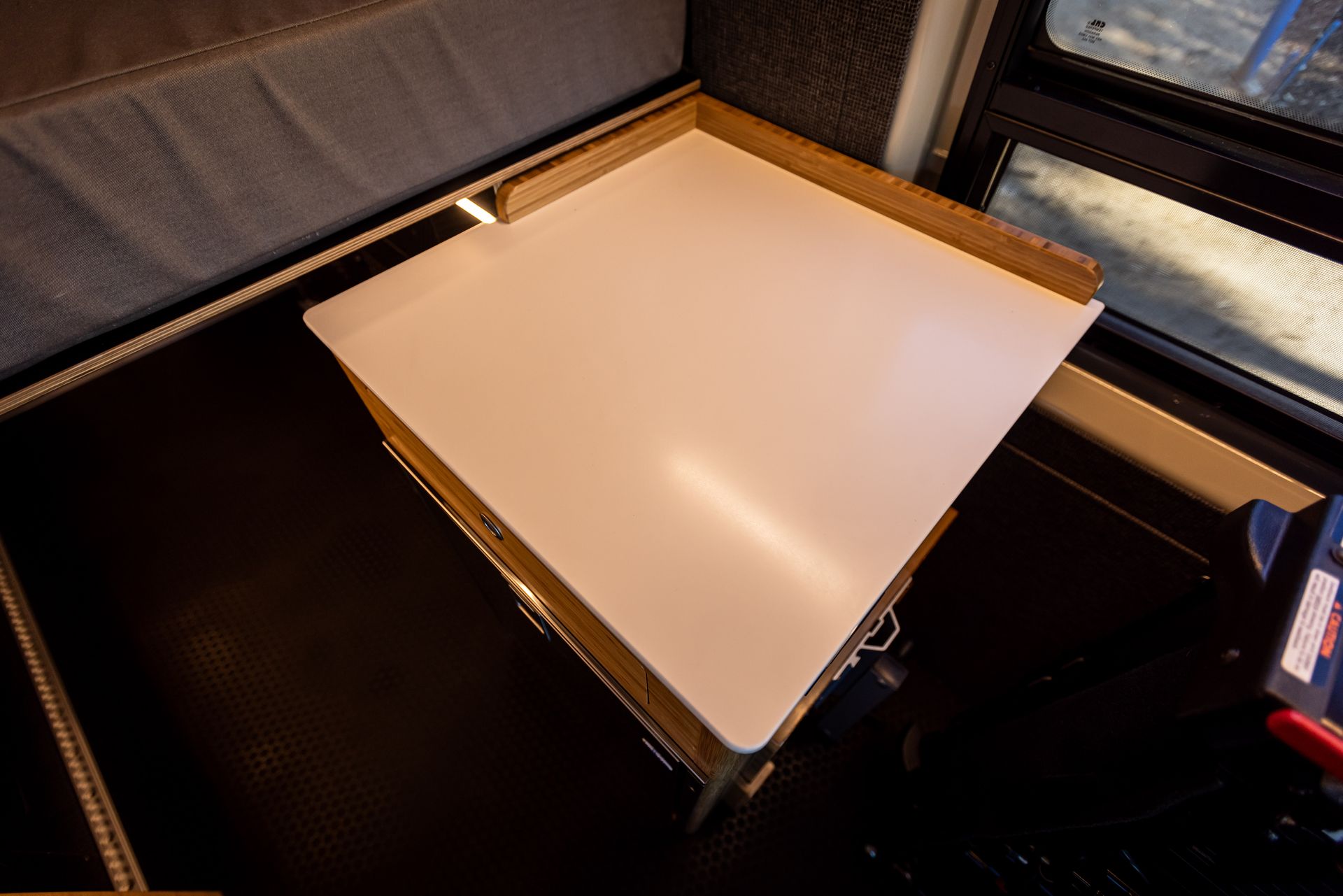 a white table with a drawer underneath it in a room .