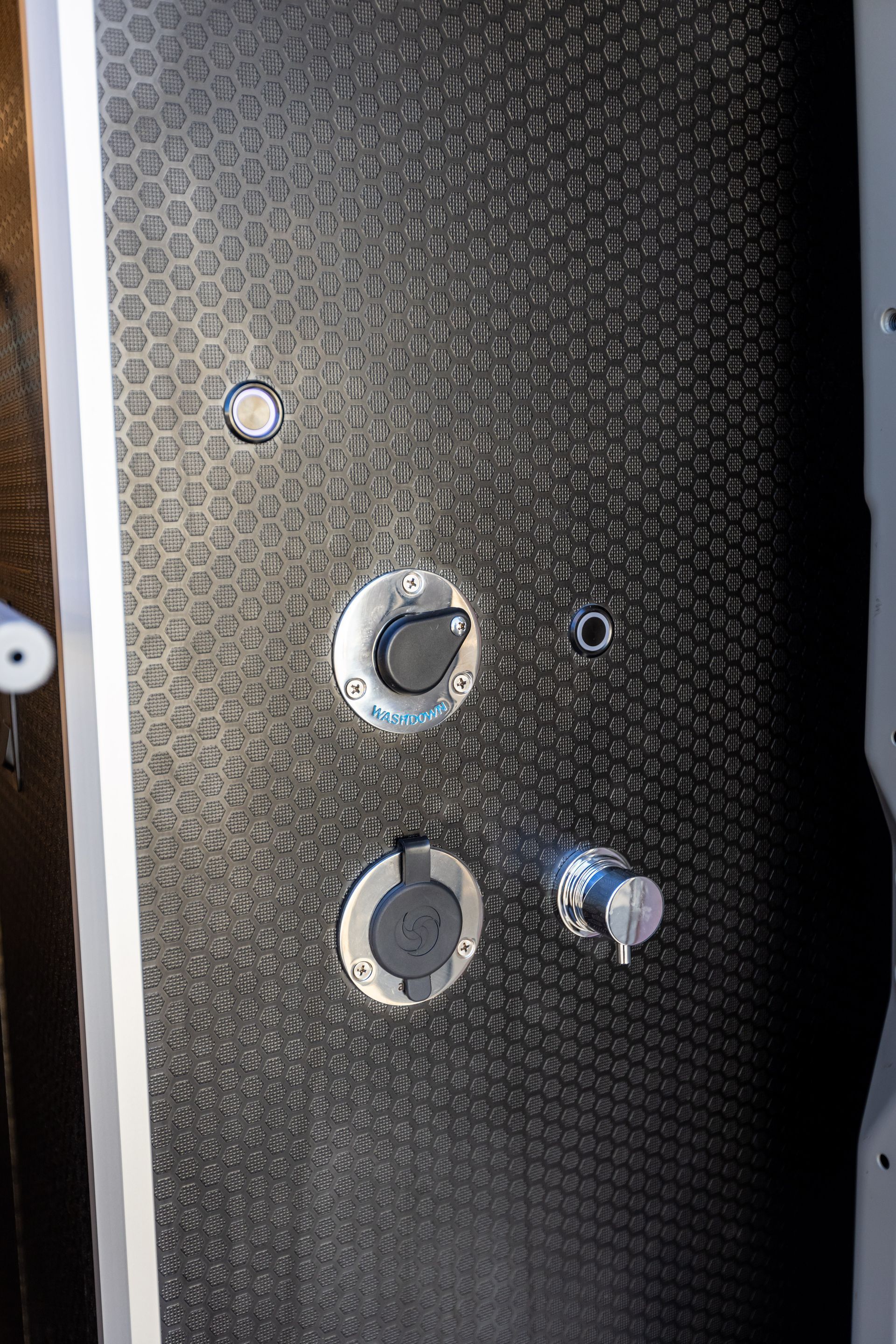 a close up of a shower head with buttons on it .