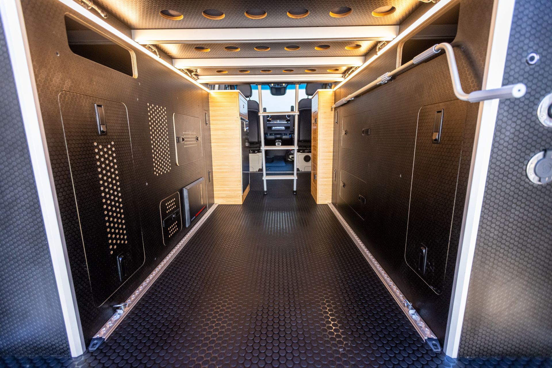 the inside of a van with a ladder in the back .