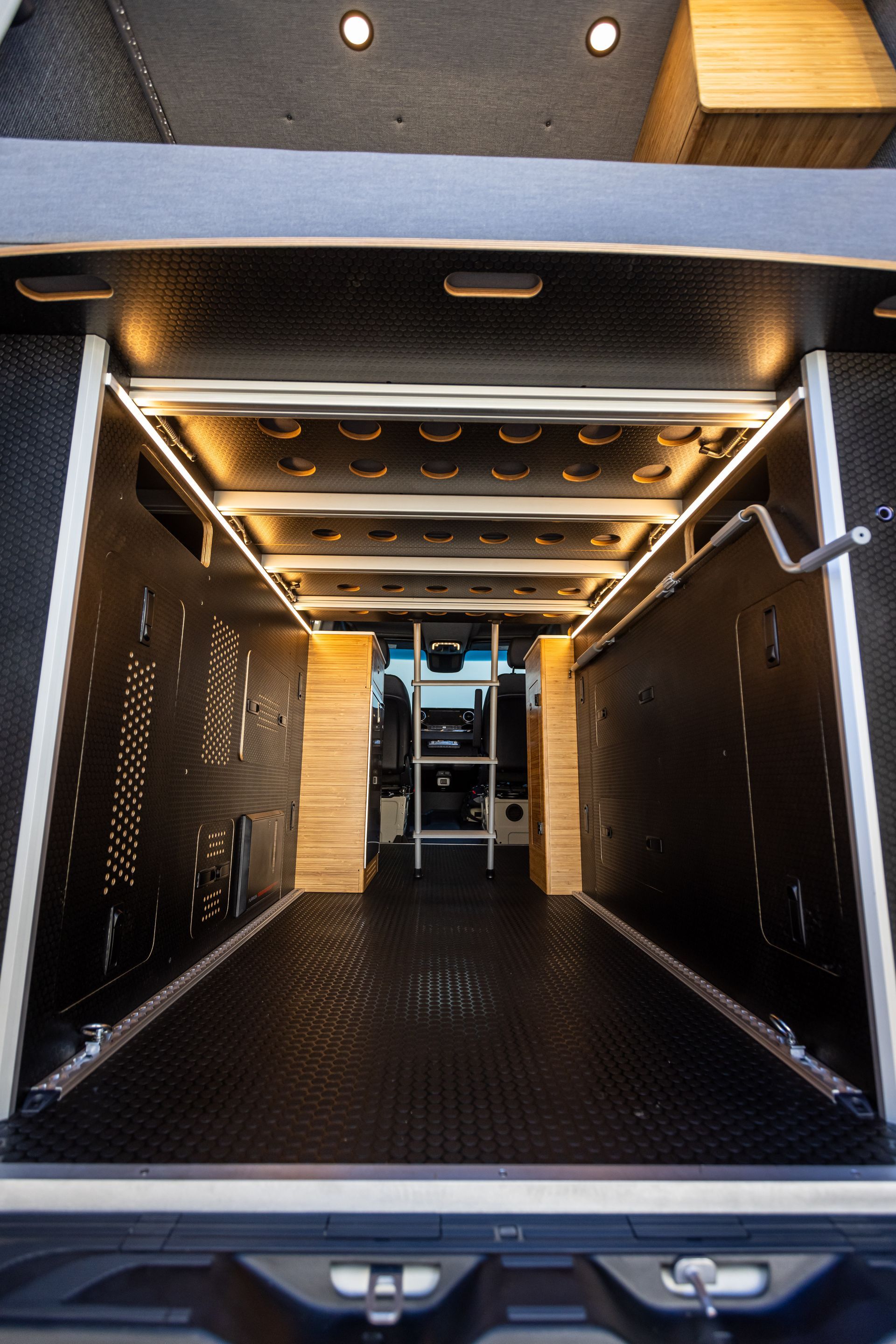 the inside of a van with a ladder in the back .