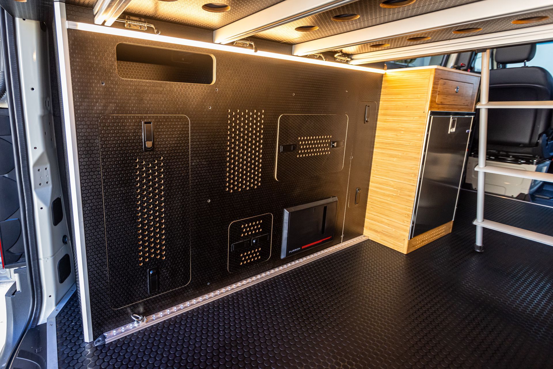 the inside of a van with a tv mounted on the wall .