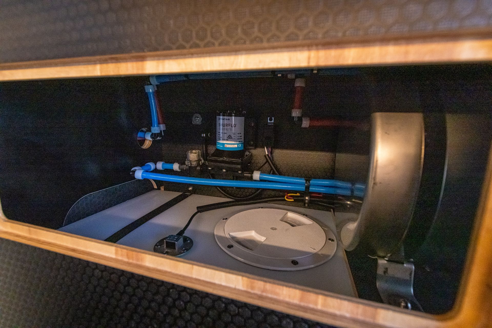 the inside of a vehicle with a fuel tank and a pump .