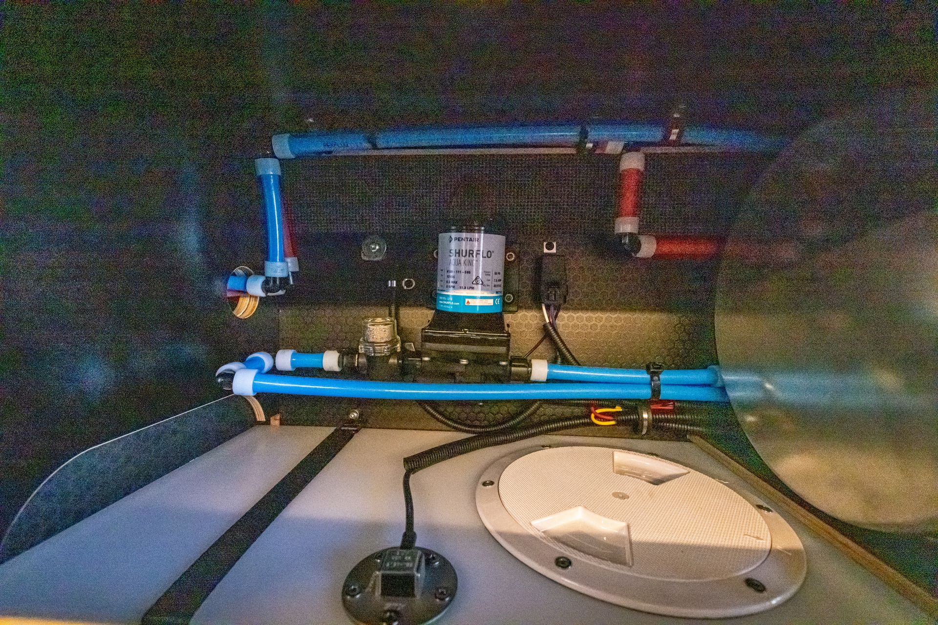 the inside of a boat with blue pipes and a microphone .