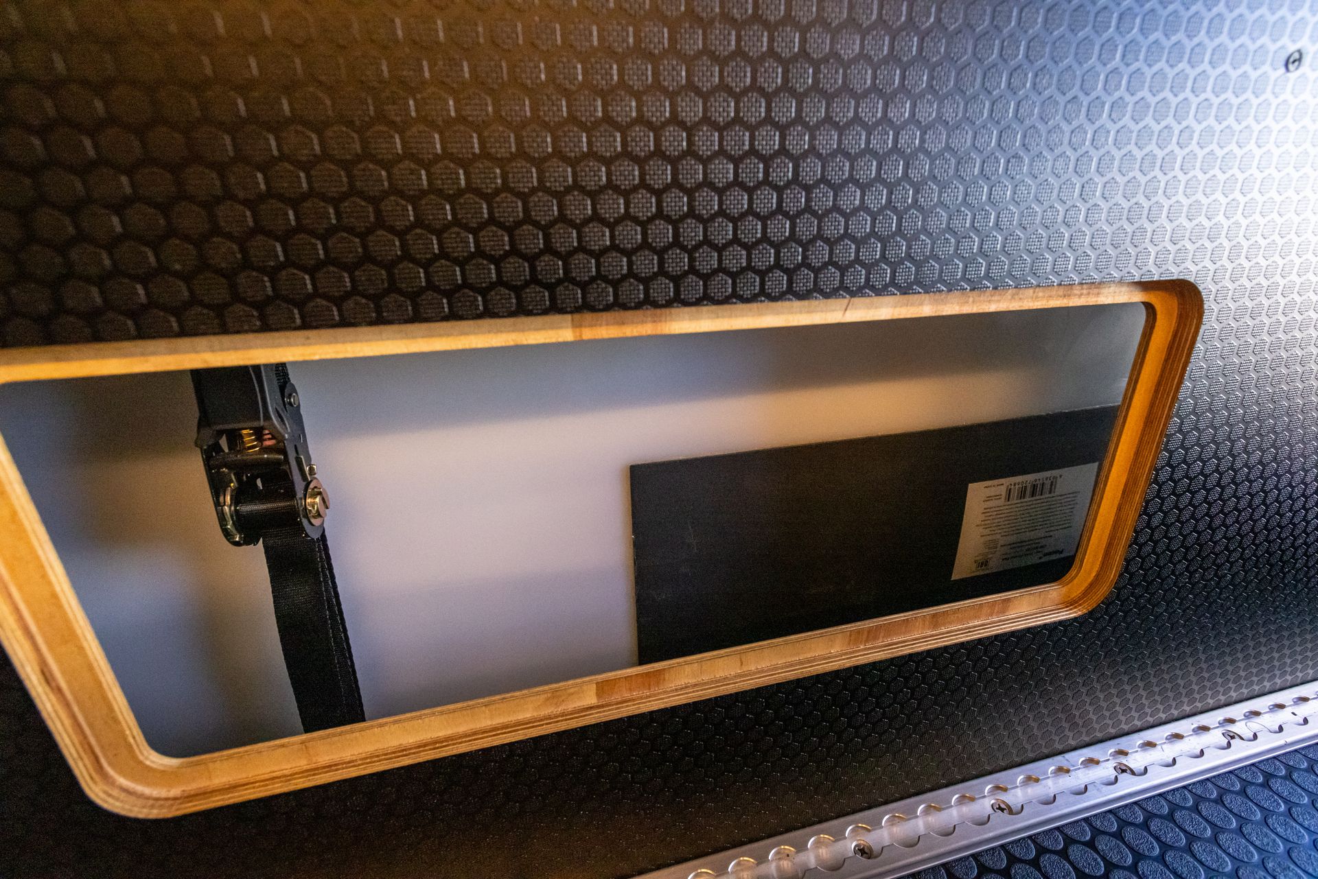 a hole in a wall with a wooden frame