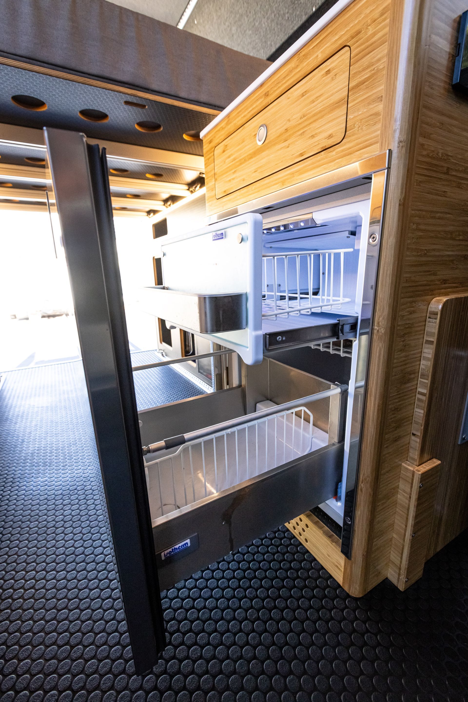 a refrigerator with a drawer open in a kitchen .