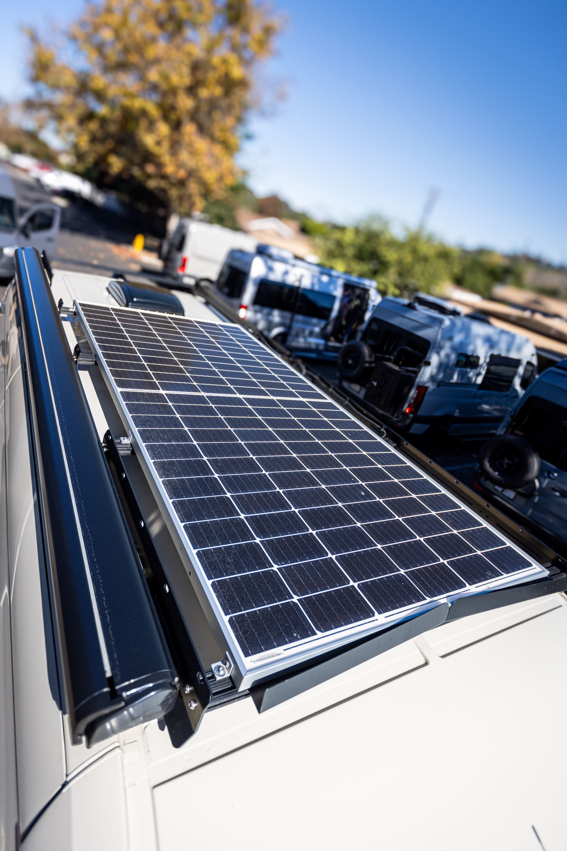 A solar panel is mounted on the roof of a van.