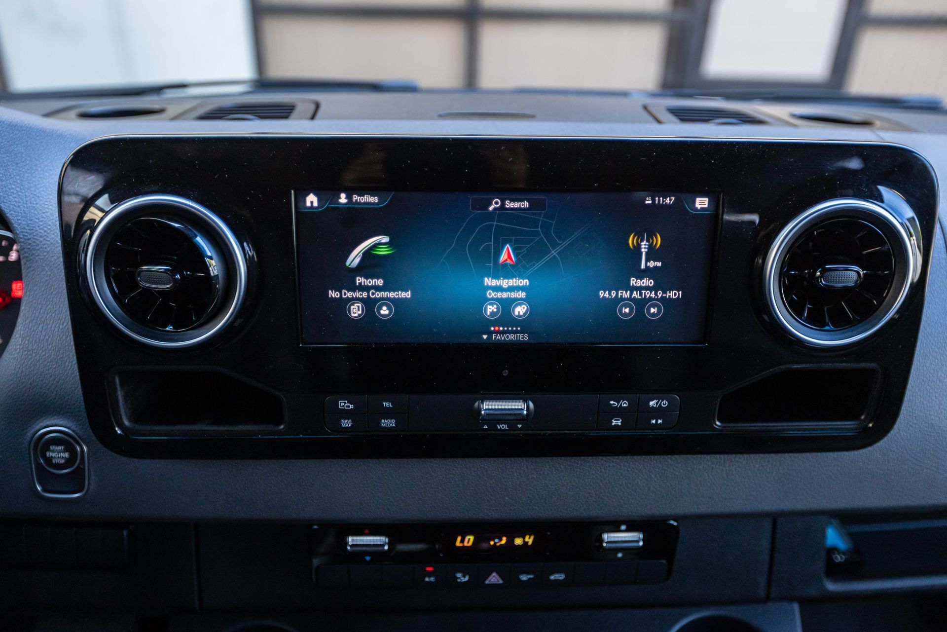 A close up of a car dashboard with a touchscreen display.