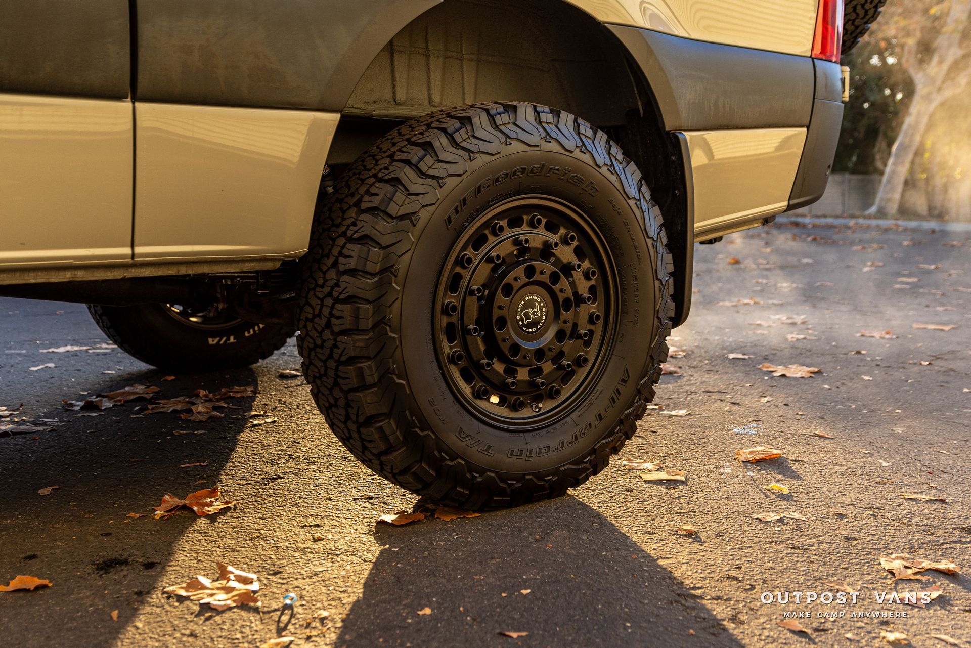 a close up of a van 's tire on a road .
