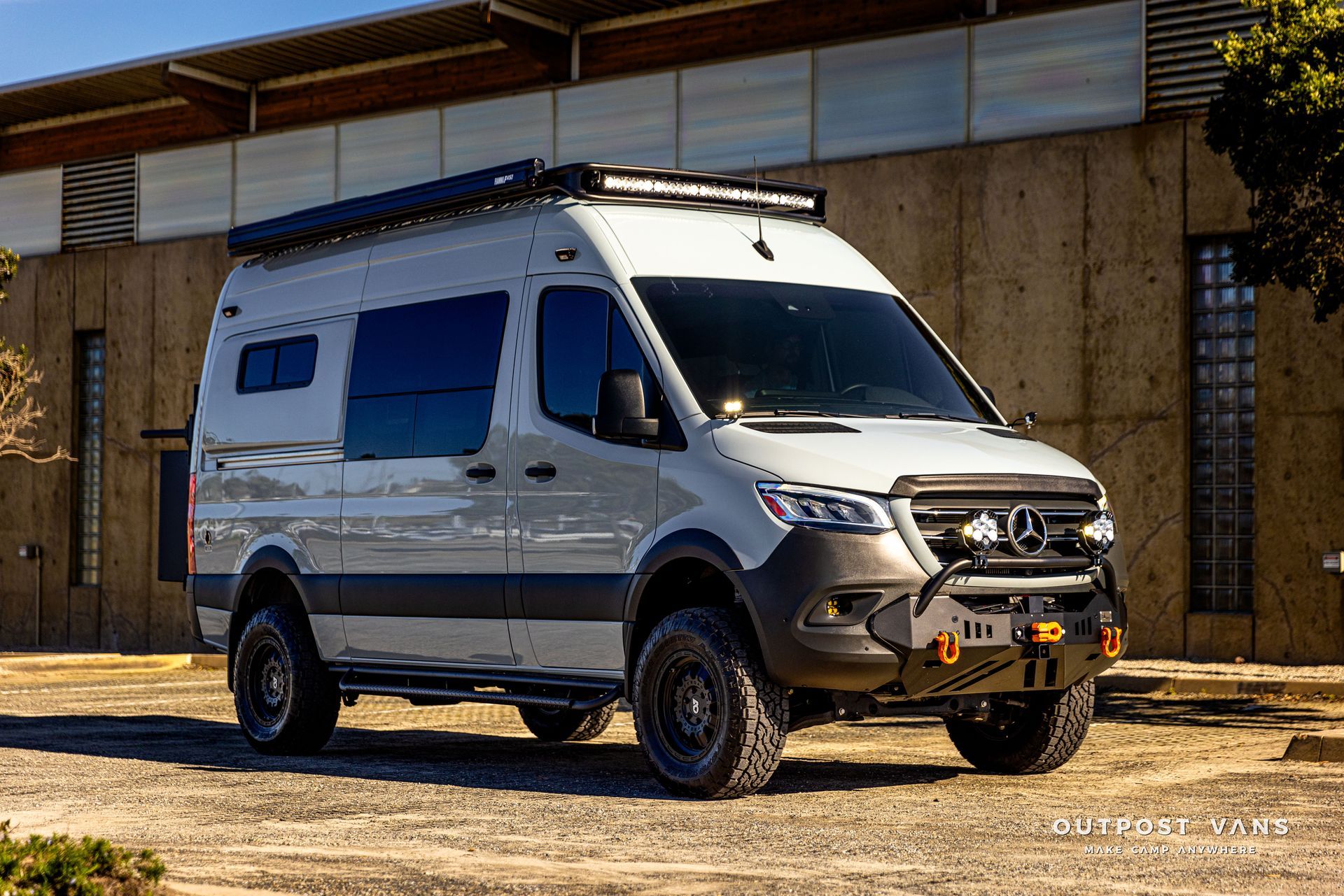 a white van is parked in front of a building .