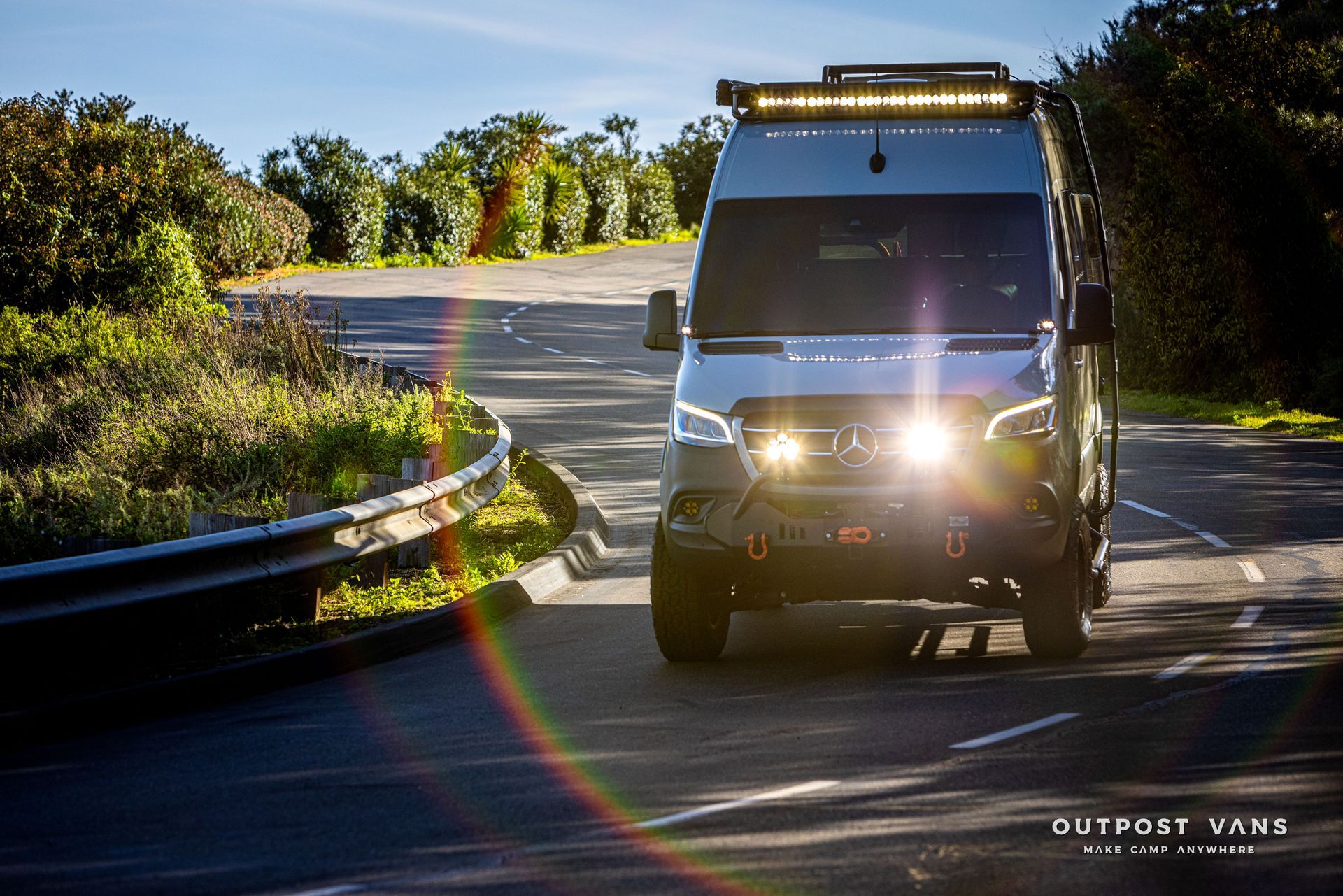 a white van is driving down a curvy road .