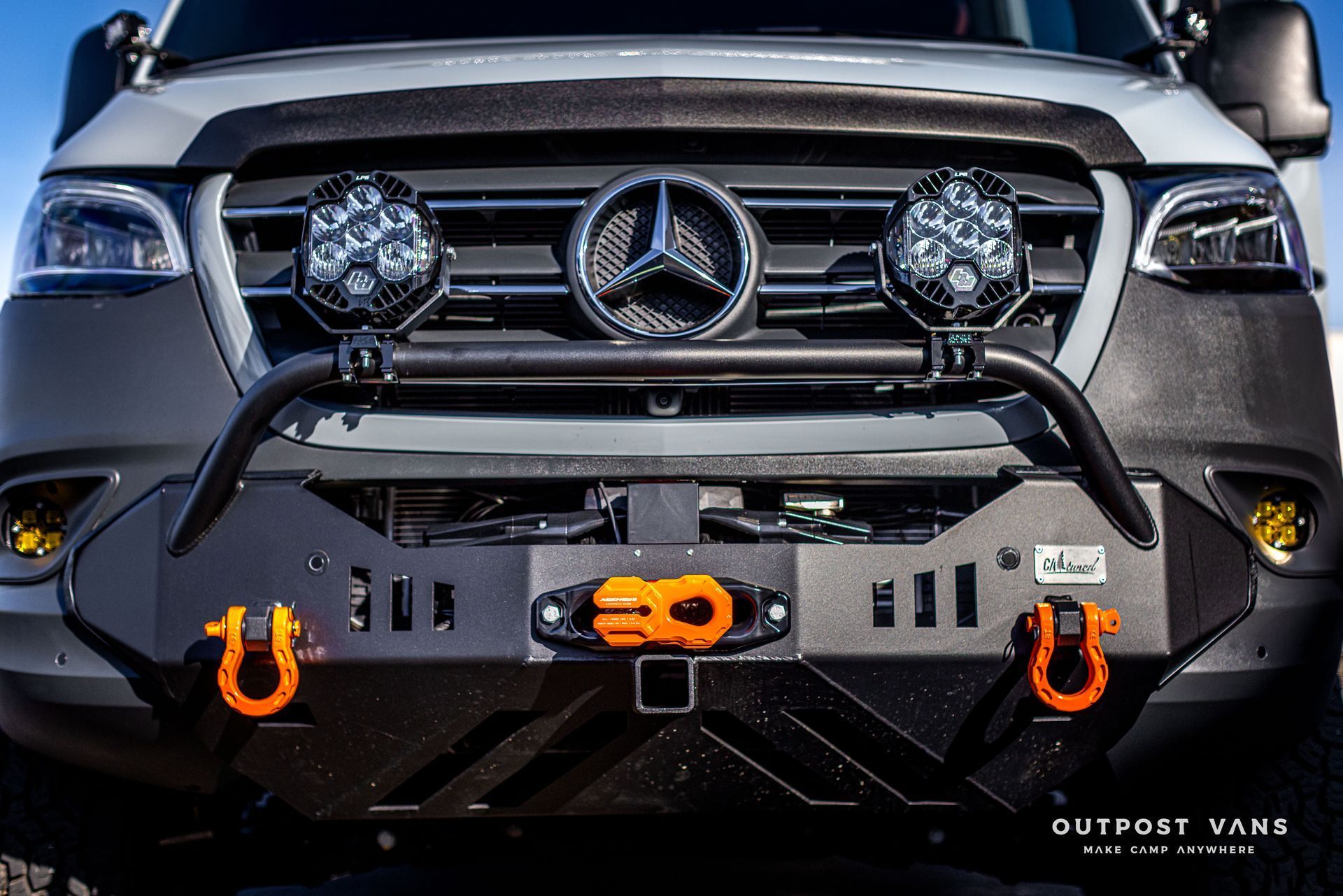 the front of a mercedes sprinter van with a bumper and lights .
