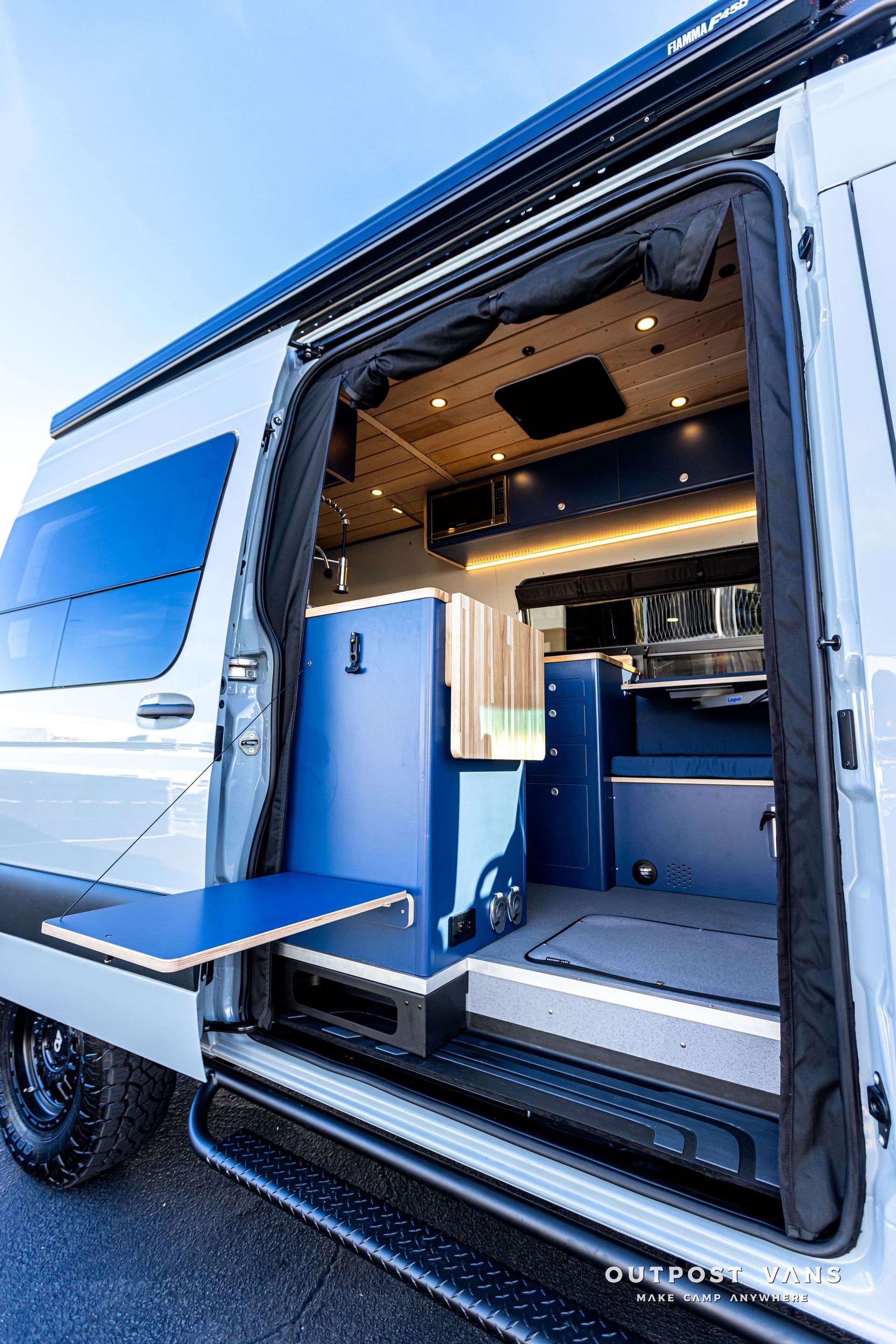 A white van with a blue table in the back of it.