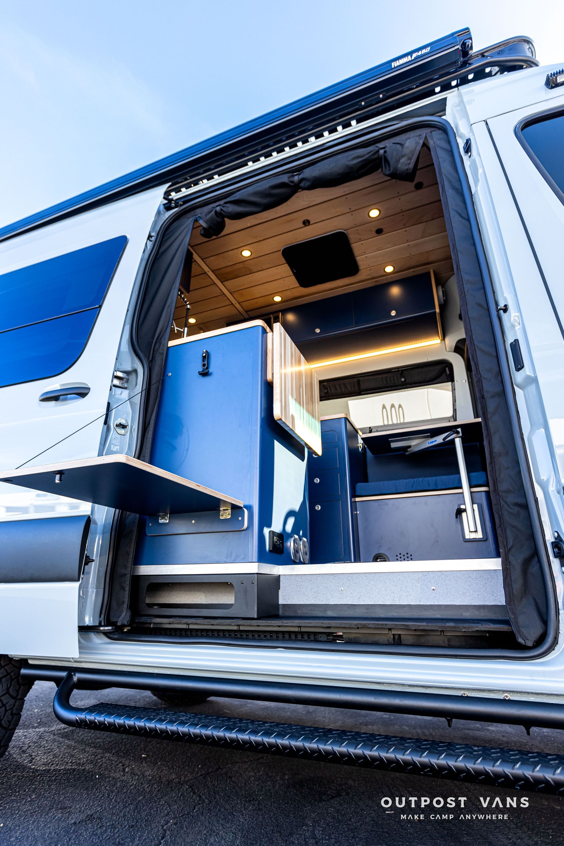 The inside of a camper van with the door open.